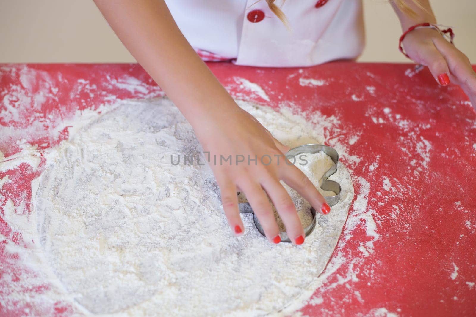 child's hand kneading with flour. Cenital plane. Kitchen by jcdiazhidalgo