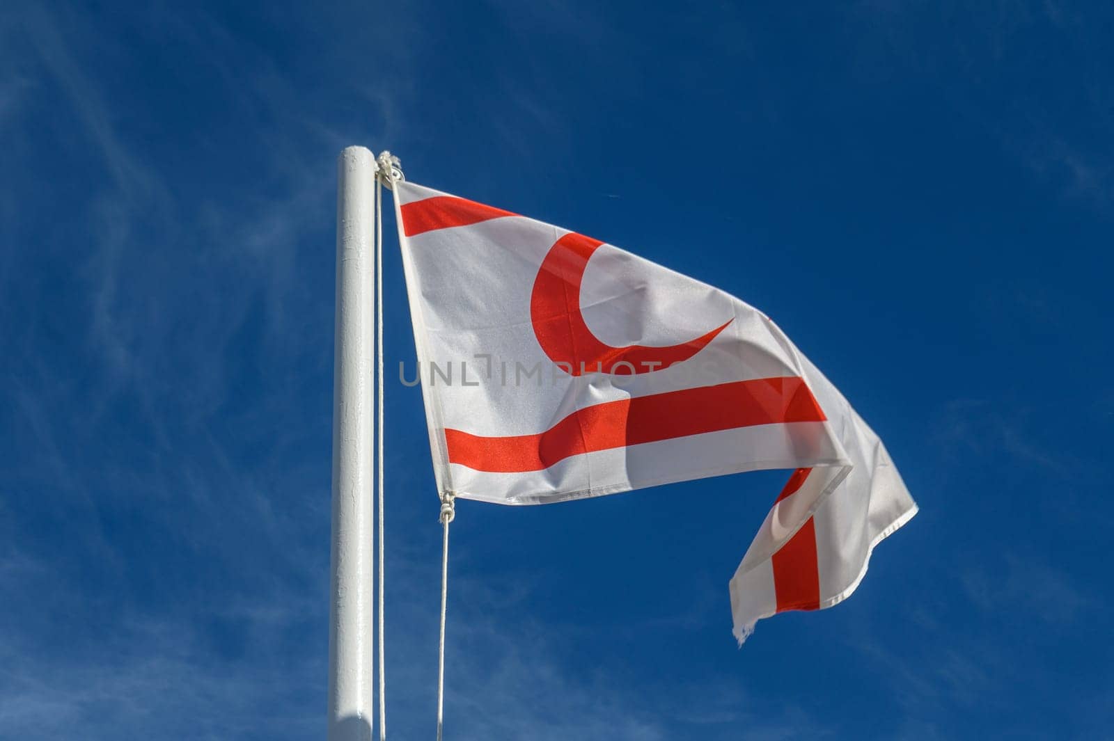 flag of the Turkish Republic of Northern Cyprus against a blue sky 2 by Mixa74