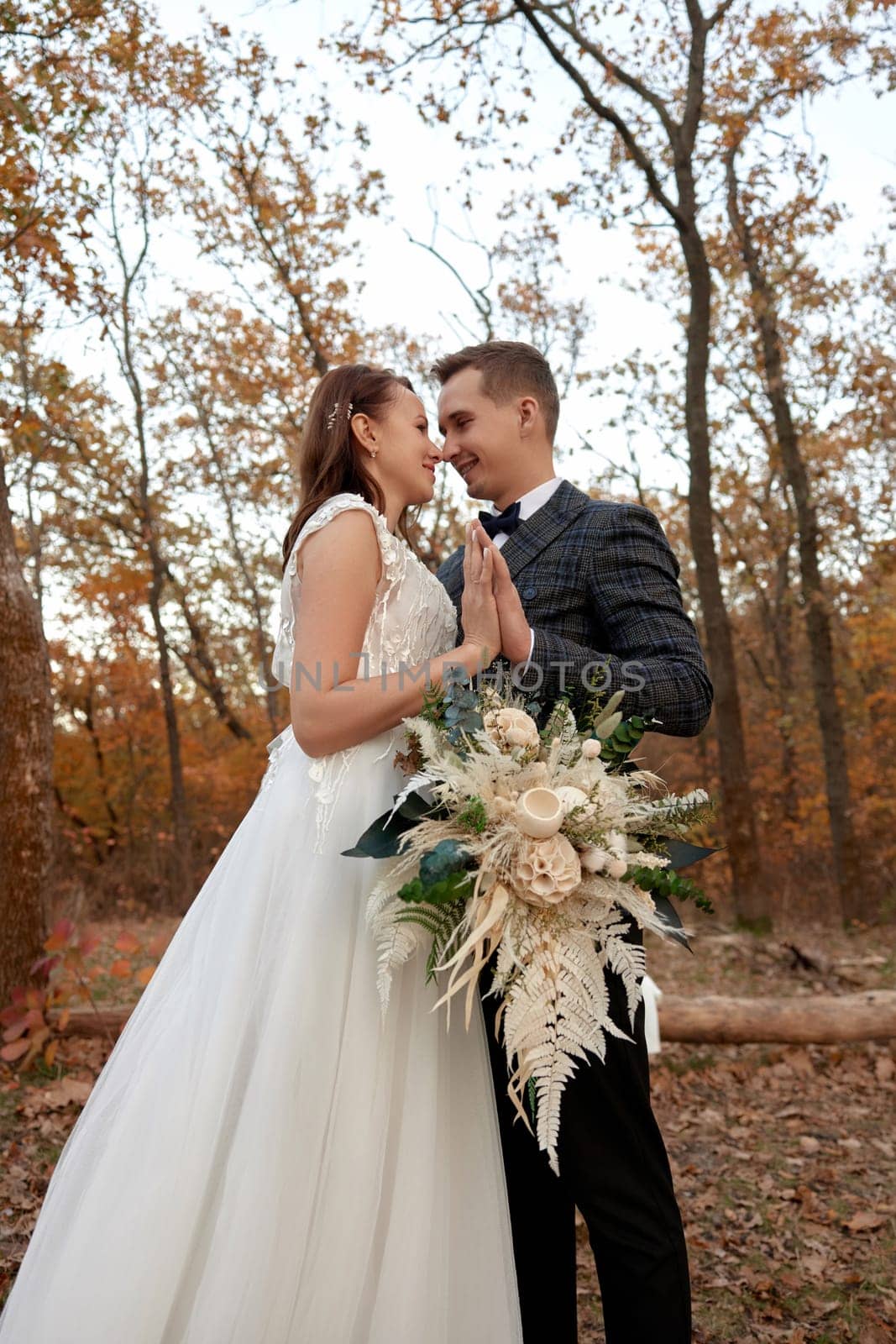 bride in white wedding dress and groom outdoor by erstudio