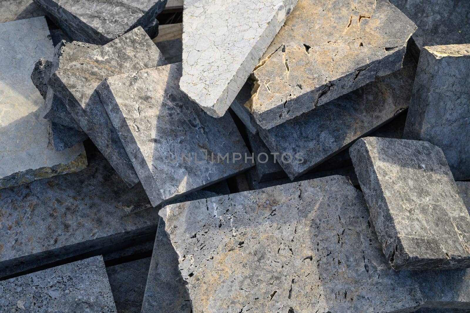 pieces of stone for paving lie in a heap as a background 13