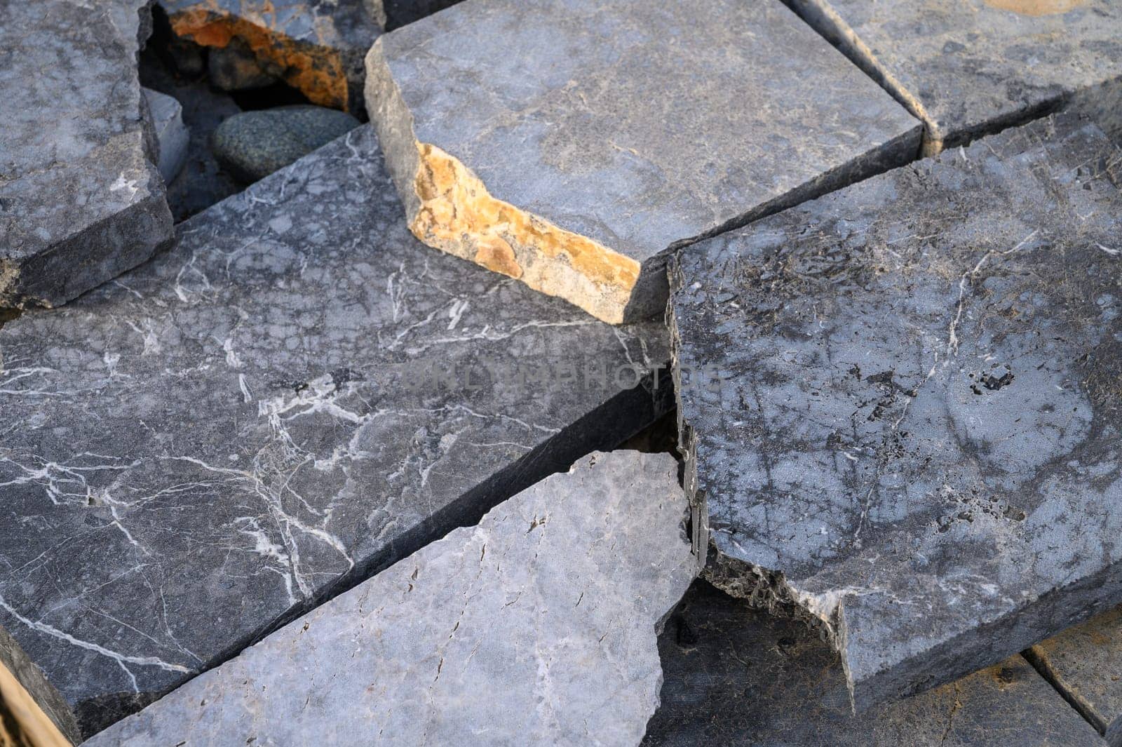 pieces of stone for paving lie in a heap as a background 9