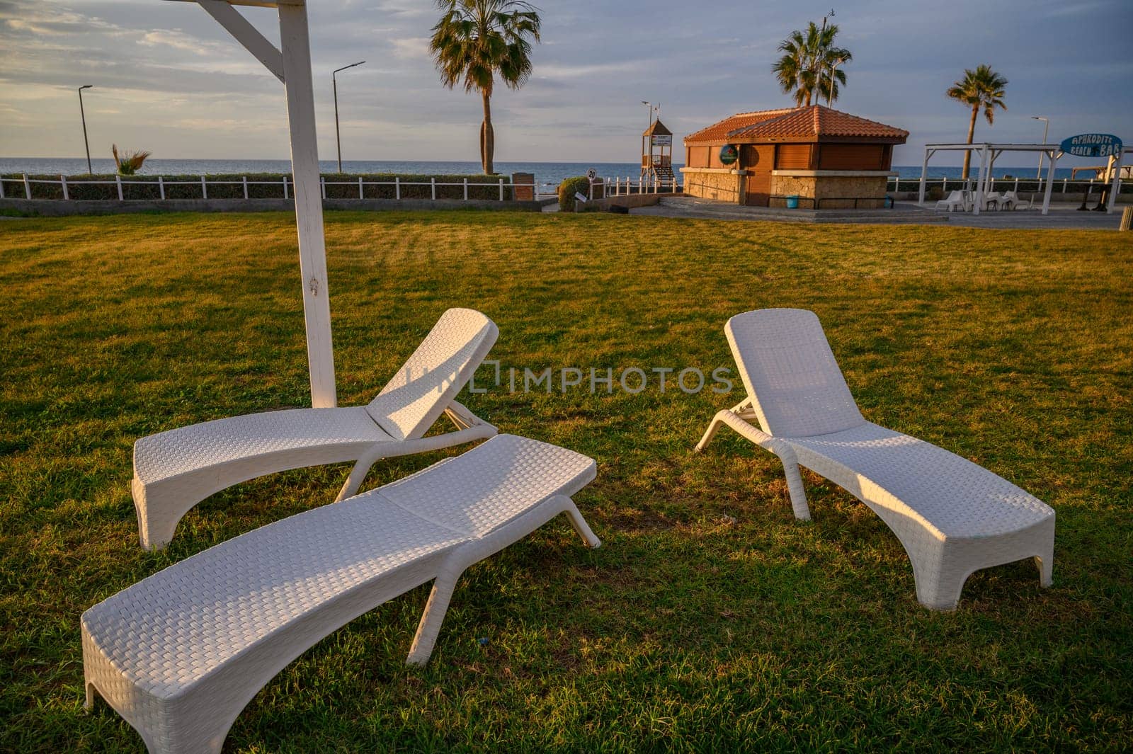 white plastic sun loungers on the Mediterranean sea 4