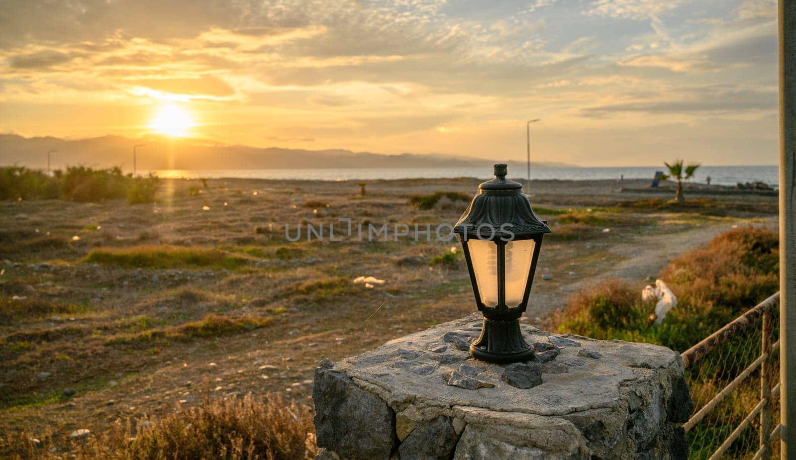 lantern on the fence at sunset