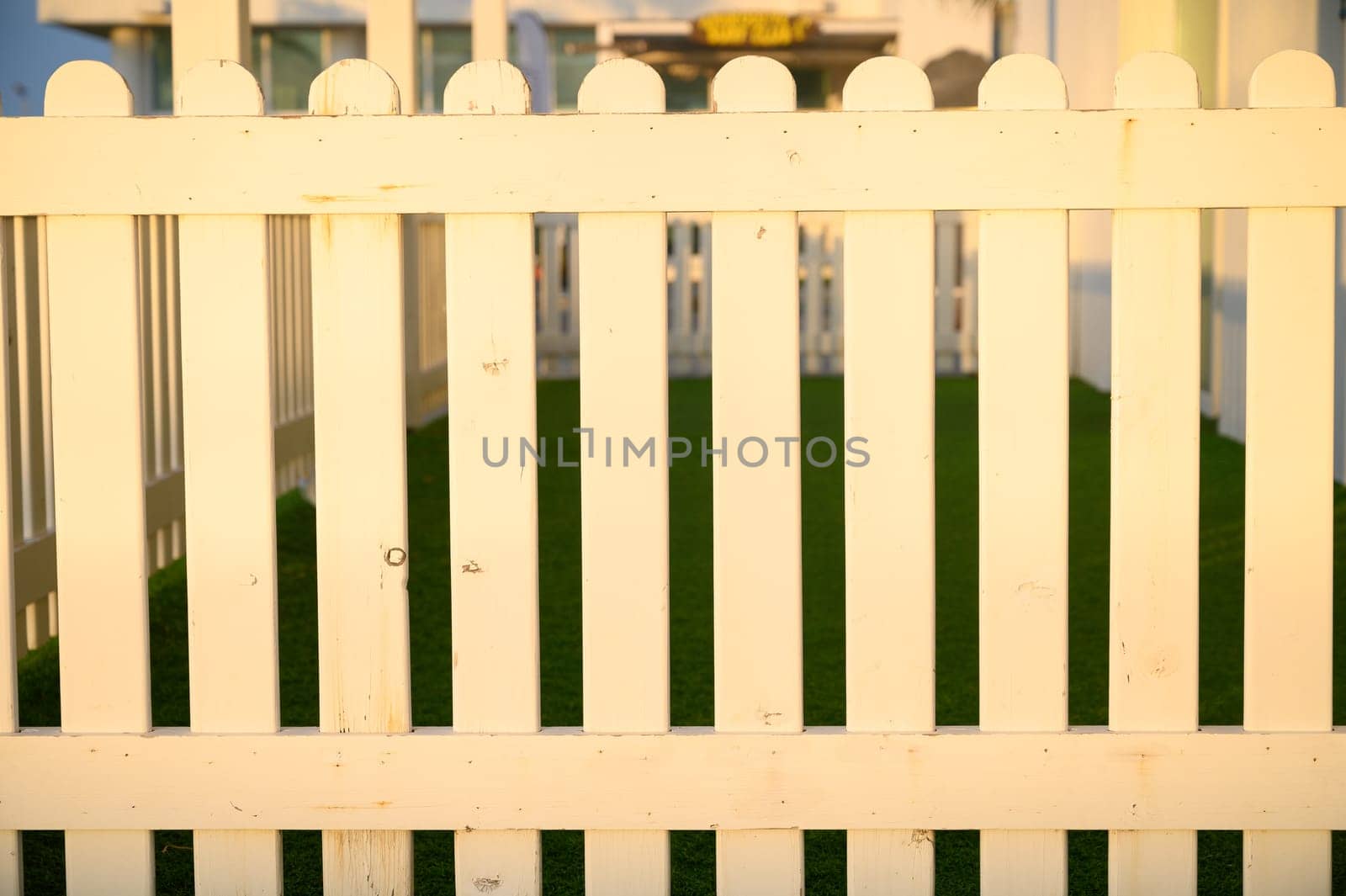 white fence in the sunset rays