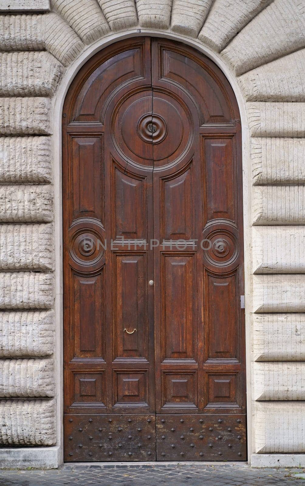 doors of Rome. Classic old wooden door in a public place on a city street or in an urban environment by aprilphoto