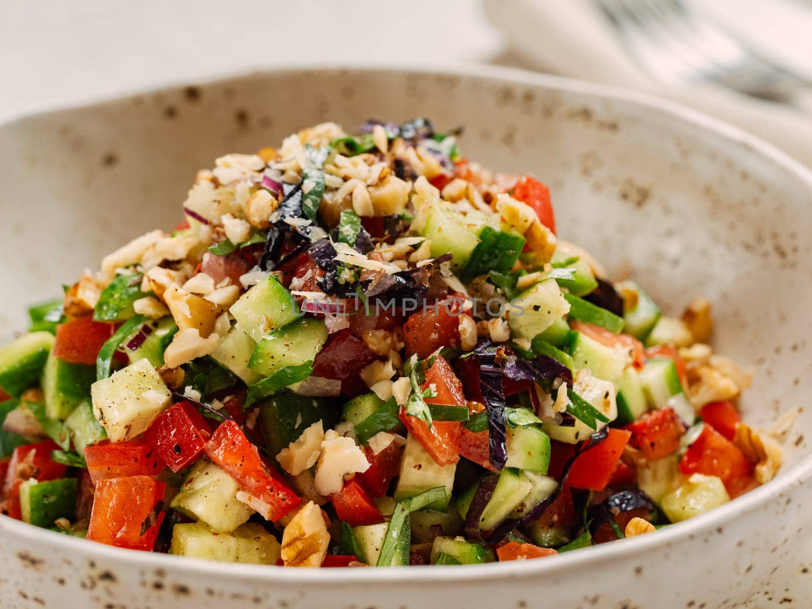 Delicious fresh vegetable salad with walnuts. Freshness in exquisite delight of delectable vegetable salad enhanced with crunchy walnut. Vegan and vegetarian food for salad lunch menu concept