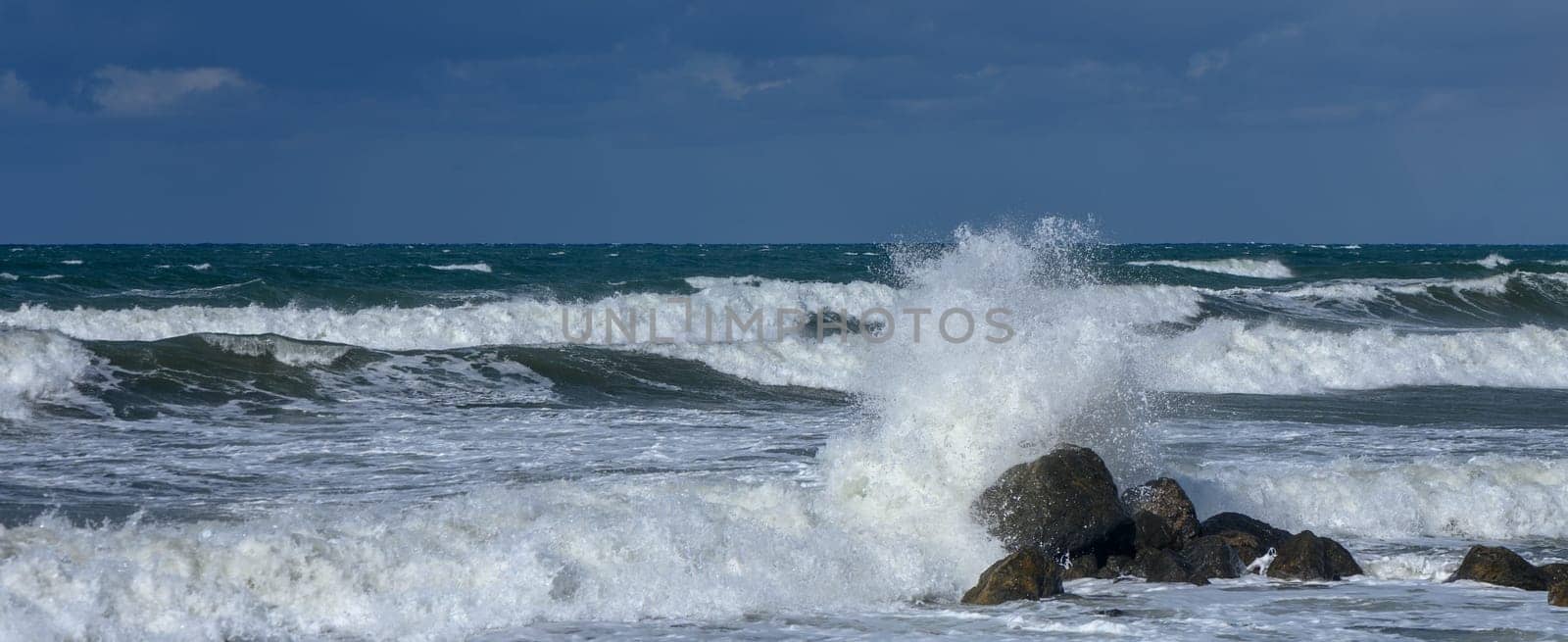 waves break on a stone in the Mediterranean Sea in autumn on the island of Cyprus
