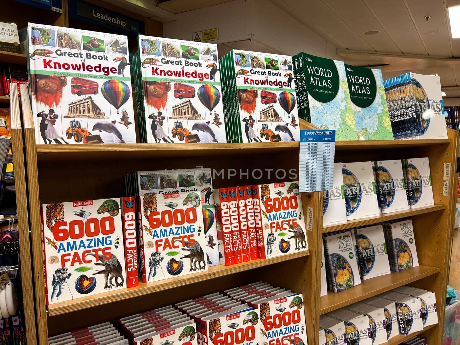 Colorful books on various knowledge, atlases and interesting facts on store shelves. High quality photo