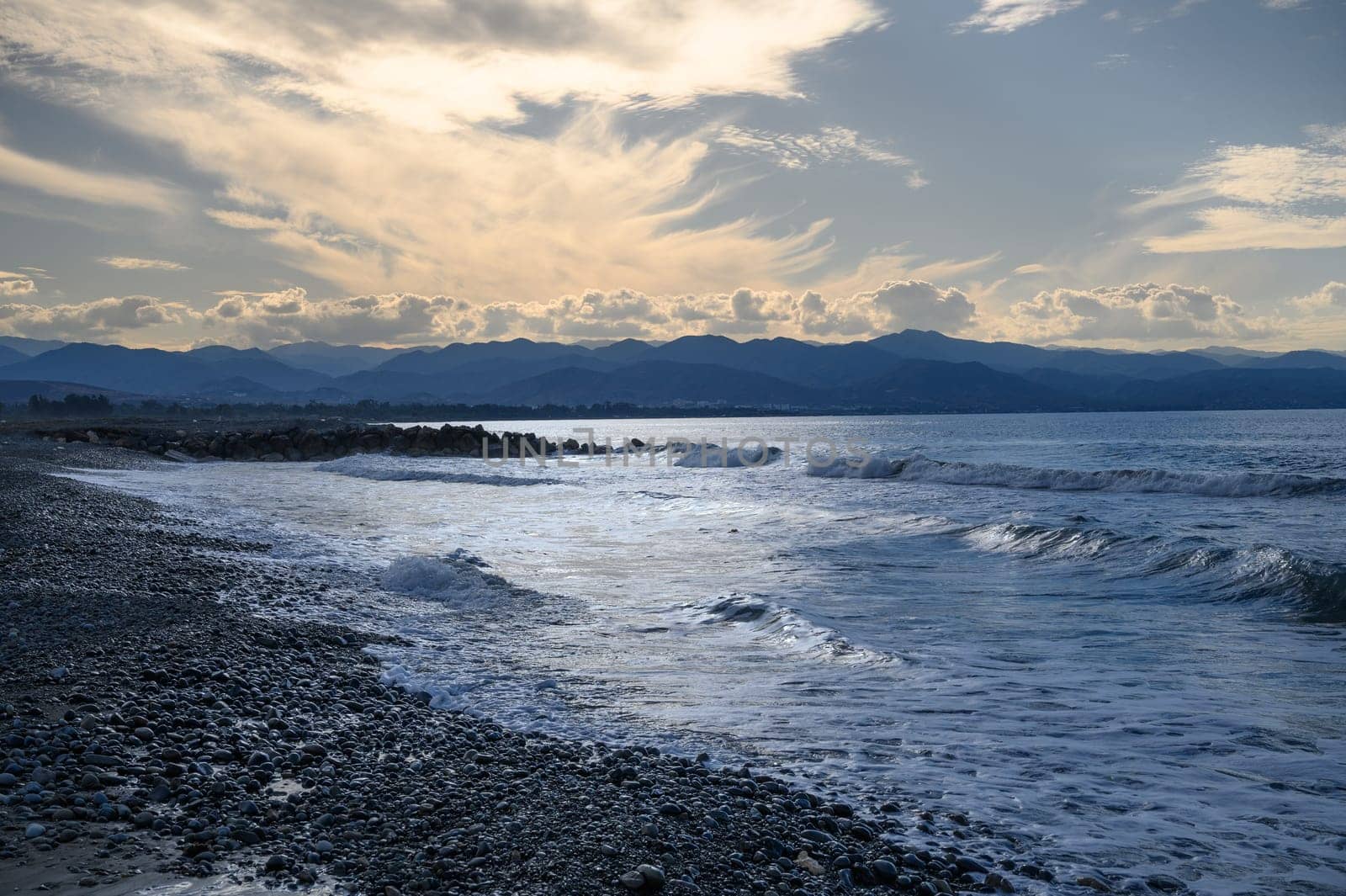 the sun sets behind a mountain on the Mediterranean coast 7