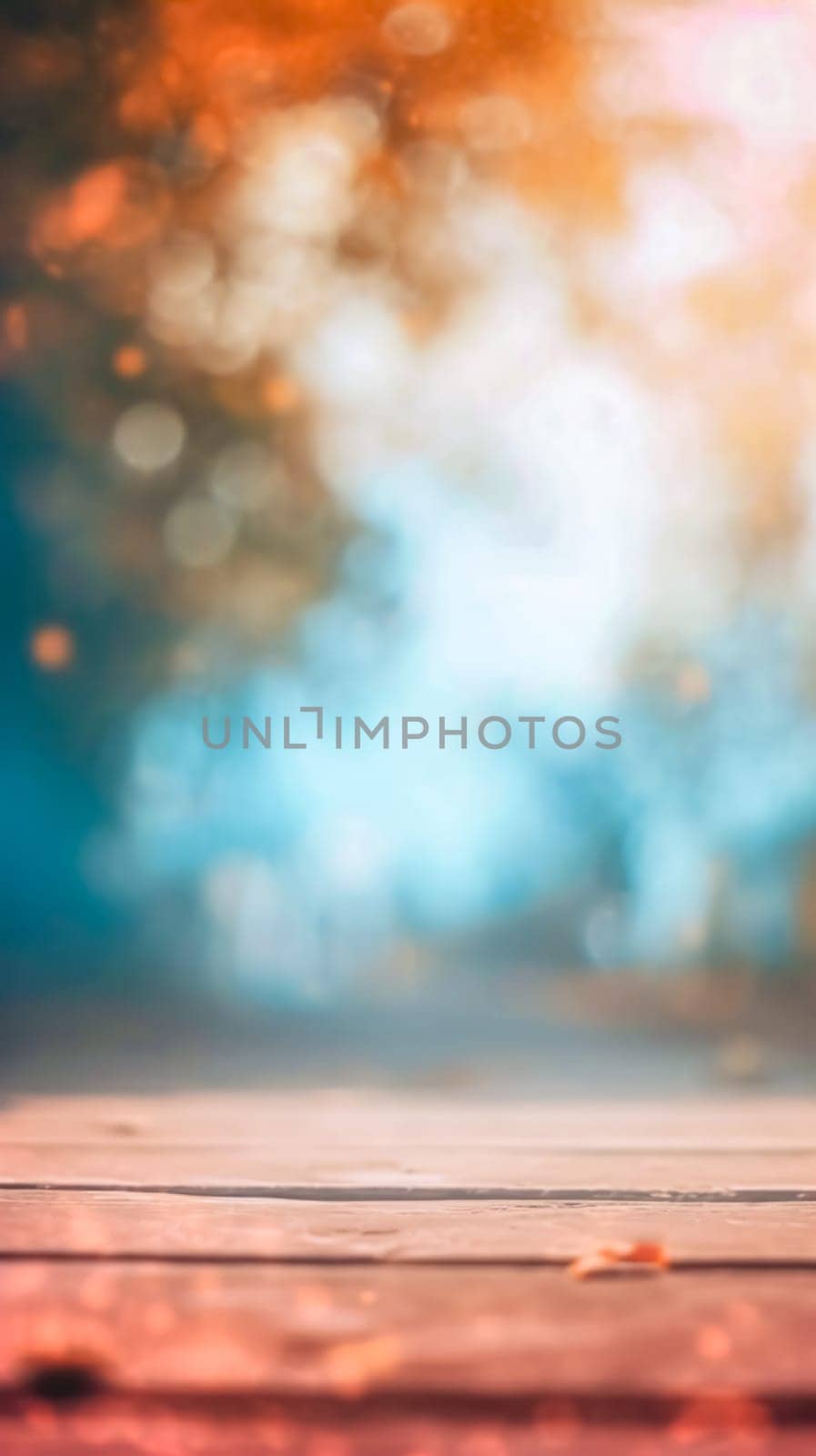 beautifully blurred photograph with a wooden surface in the foreground leading to a bokeh of warm and cool lights, suggesting an autumnal scene or a magical, dreamy atmosphere by Edophoto