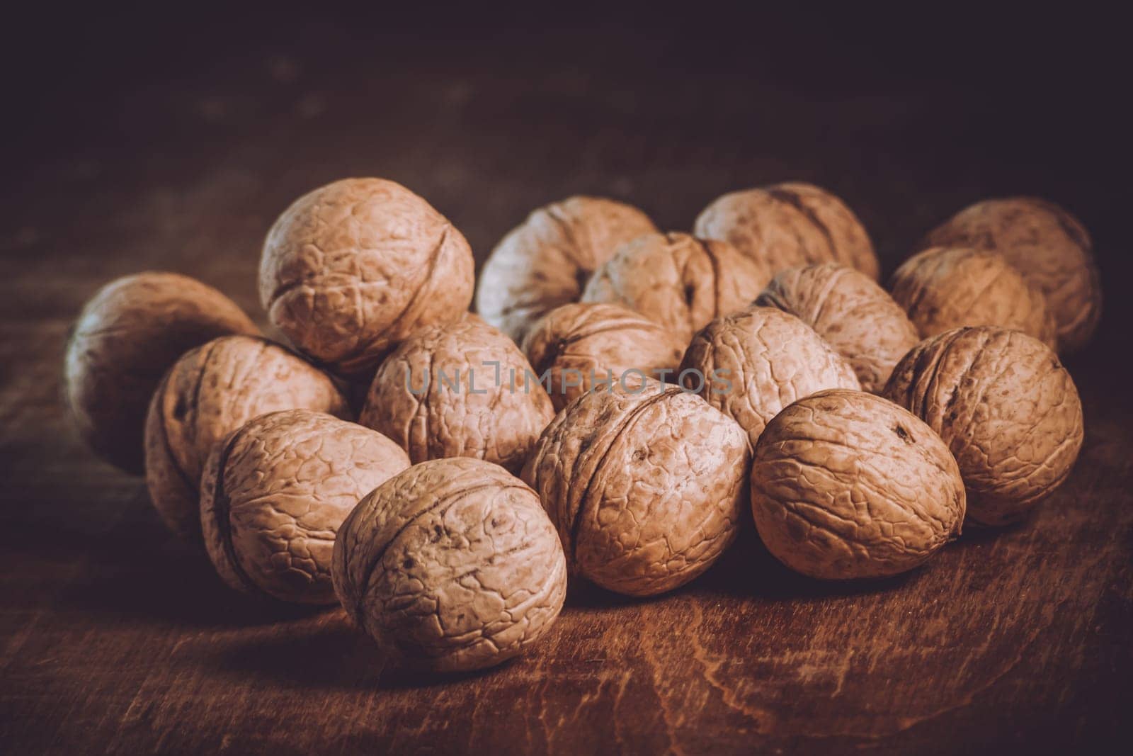 Nuts are scattered on the table. Healthy food. Walnuts lie on the table. Healthy food. Nuts on an old wooden surface.