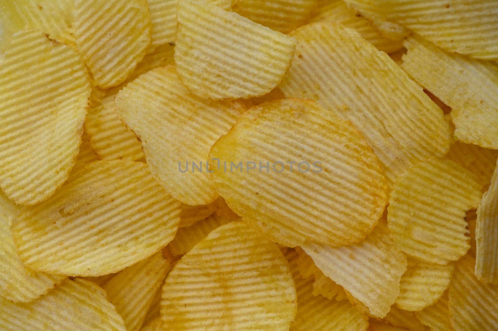 food background from delicious chips poured out of a pack