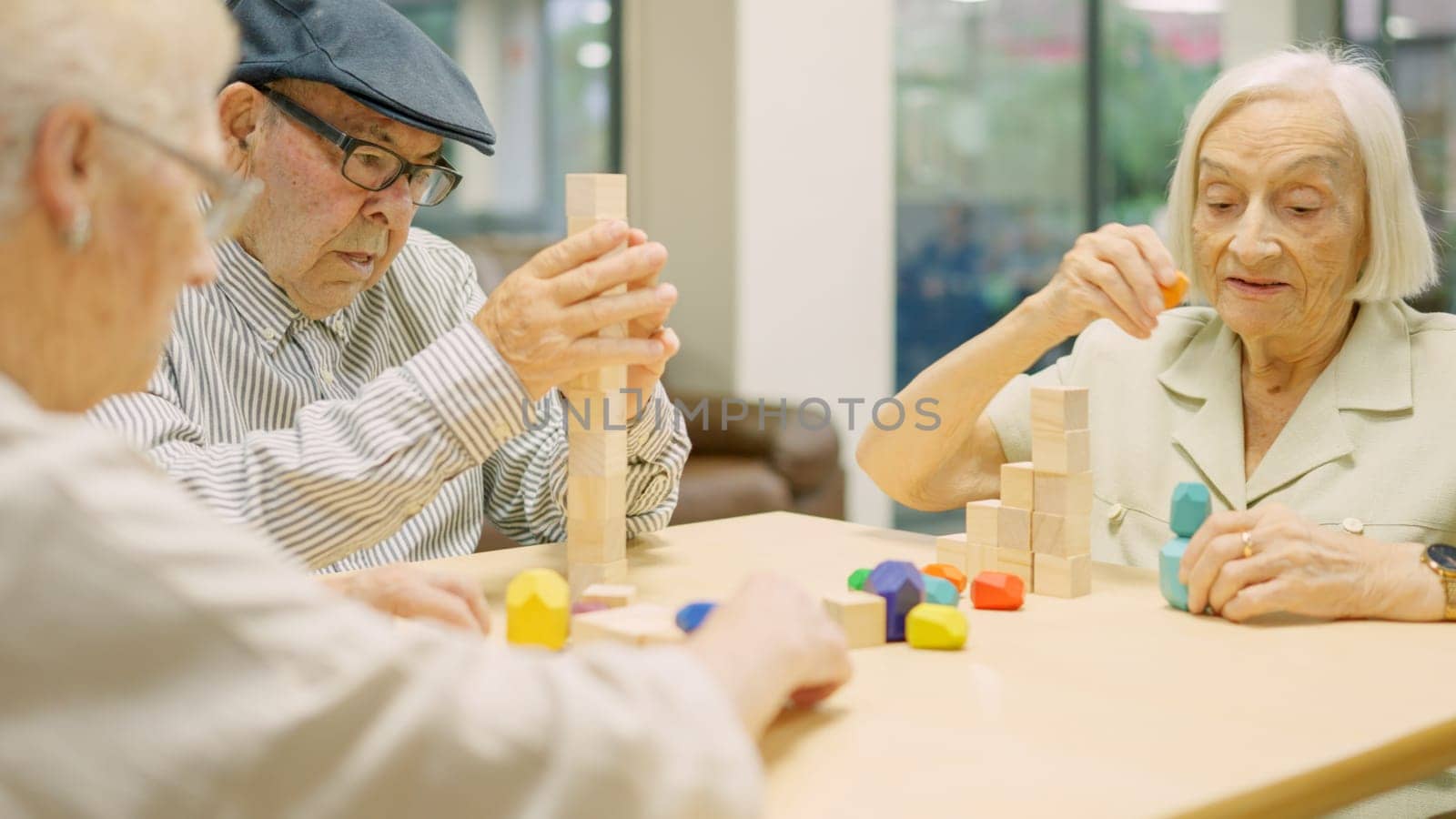 Three concentrated seniors resolving brain skill games with wooden pieces in a geriatric