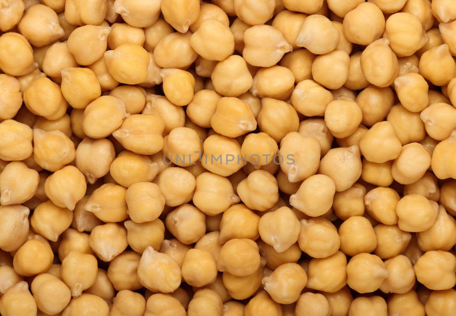 Cooked soaked chickpea legume beans (Cicer arietinum) close up pattern background, elevated top view, directly above