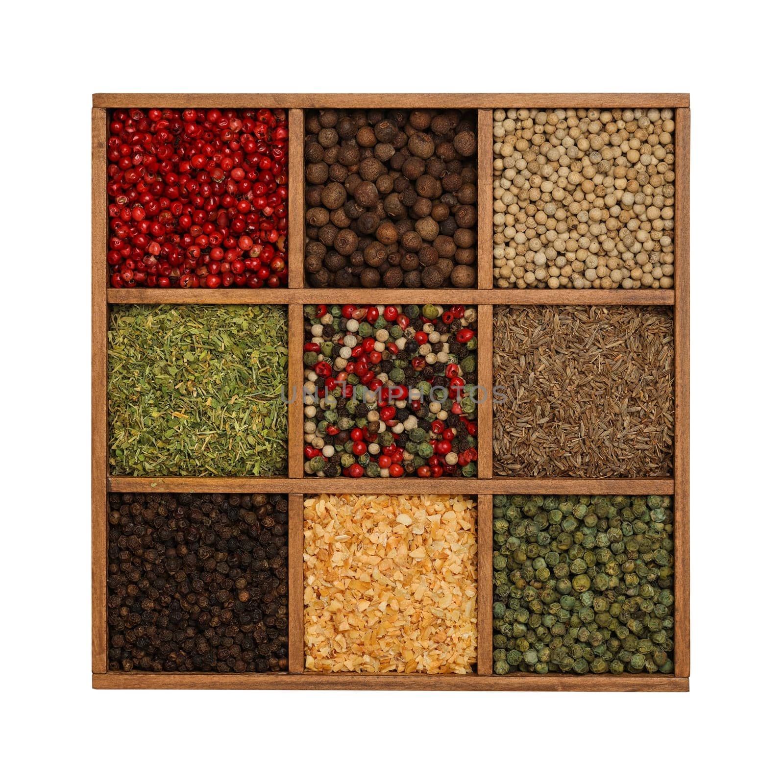 Assorted fresh colorful spices and condiments in a wooden organizer box, isolated on white background, elevated top view, directly above