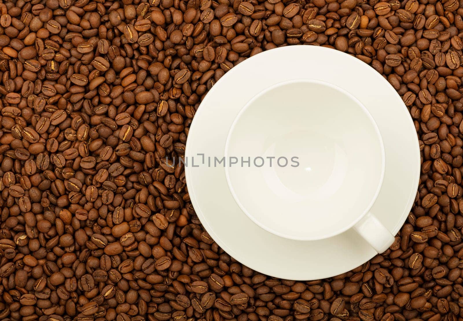 Empty white cup over roasted coffee beans by BreakingTheWalls