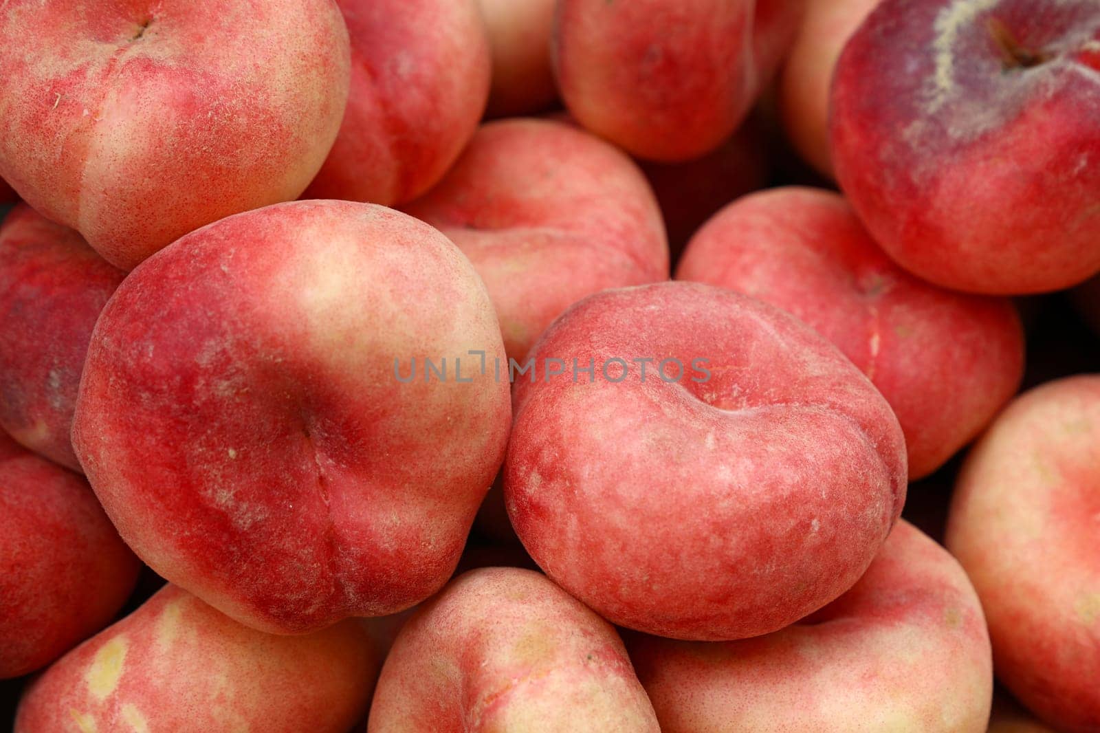 Close up fresh peaches at retail display of farmer market, high angle view