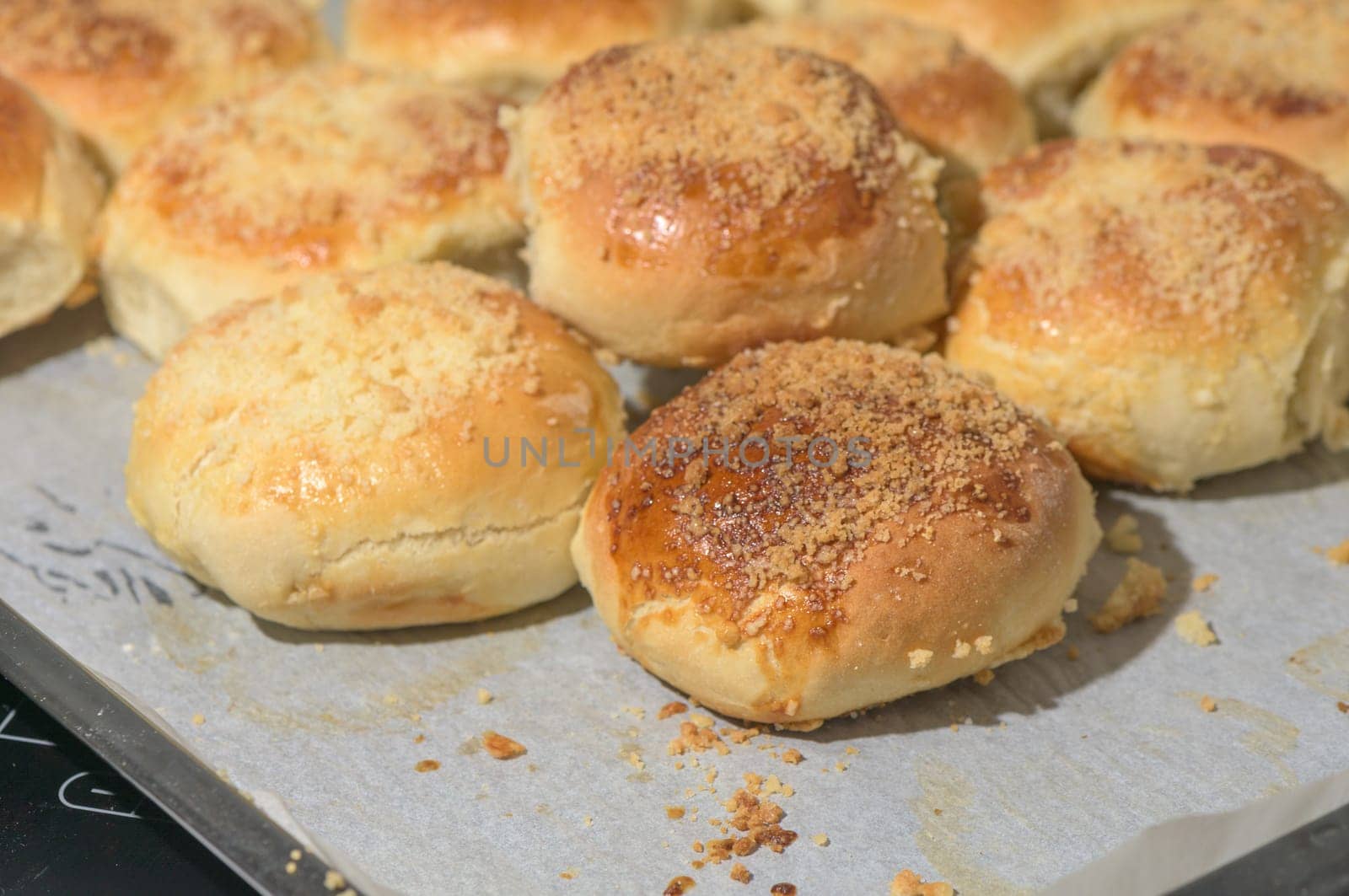 homemade bread rolls on parchment on a baking sheet 2