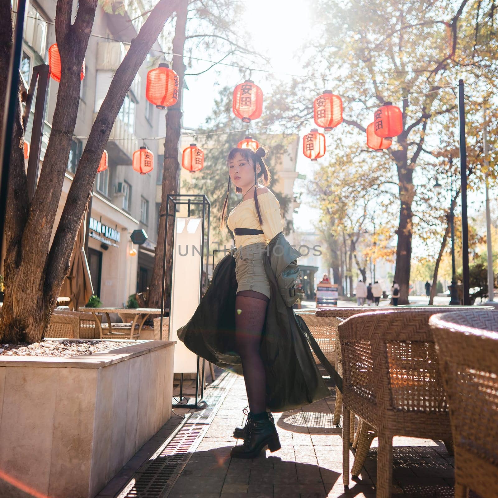 Full length portrait of Asian woman in front of Chinese lanterns