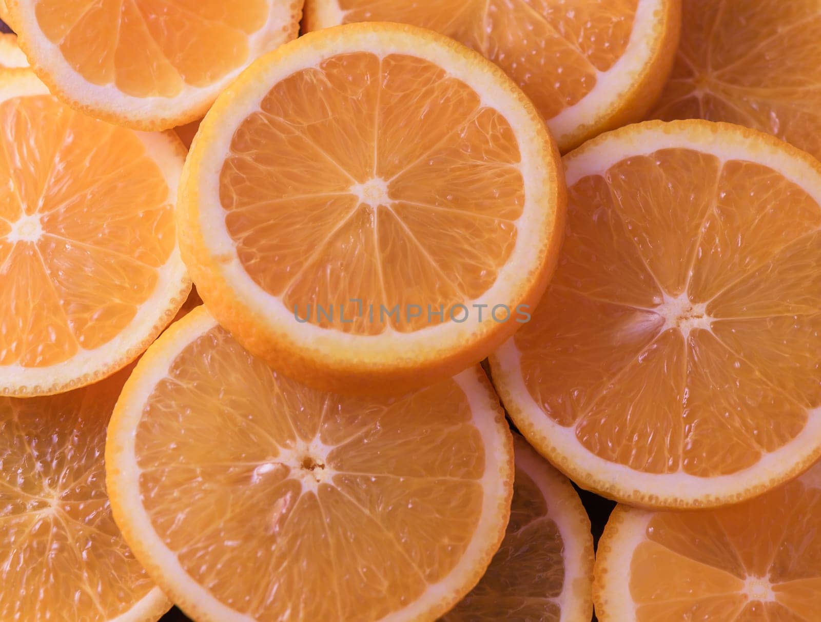 oranges cut into slices and laid out on the table as a food background 2