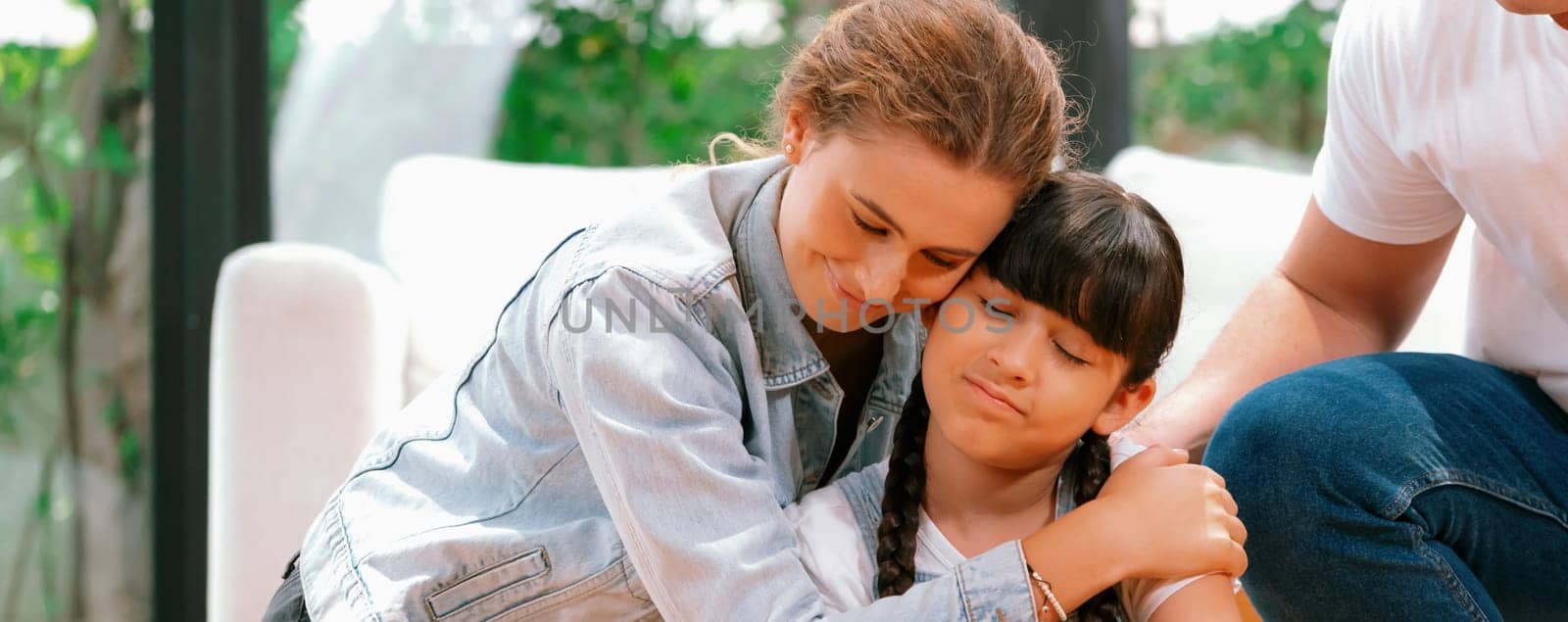 Parents comforting their daughter with loving hug, helping her feel secure and protected from fear, rest her head on shoulder and sadness melts away. Family love and child care Panorama. Synchronos