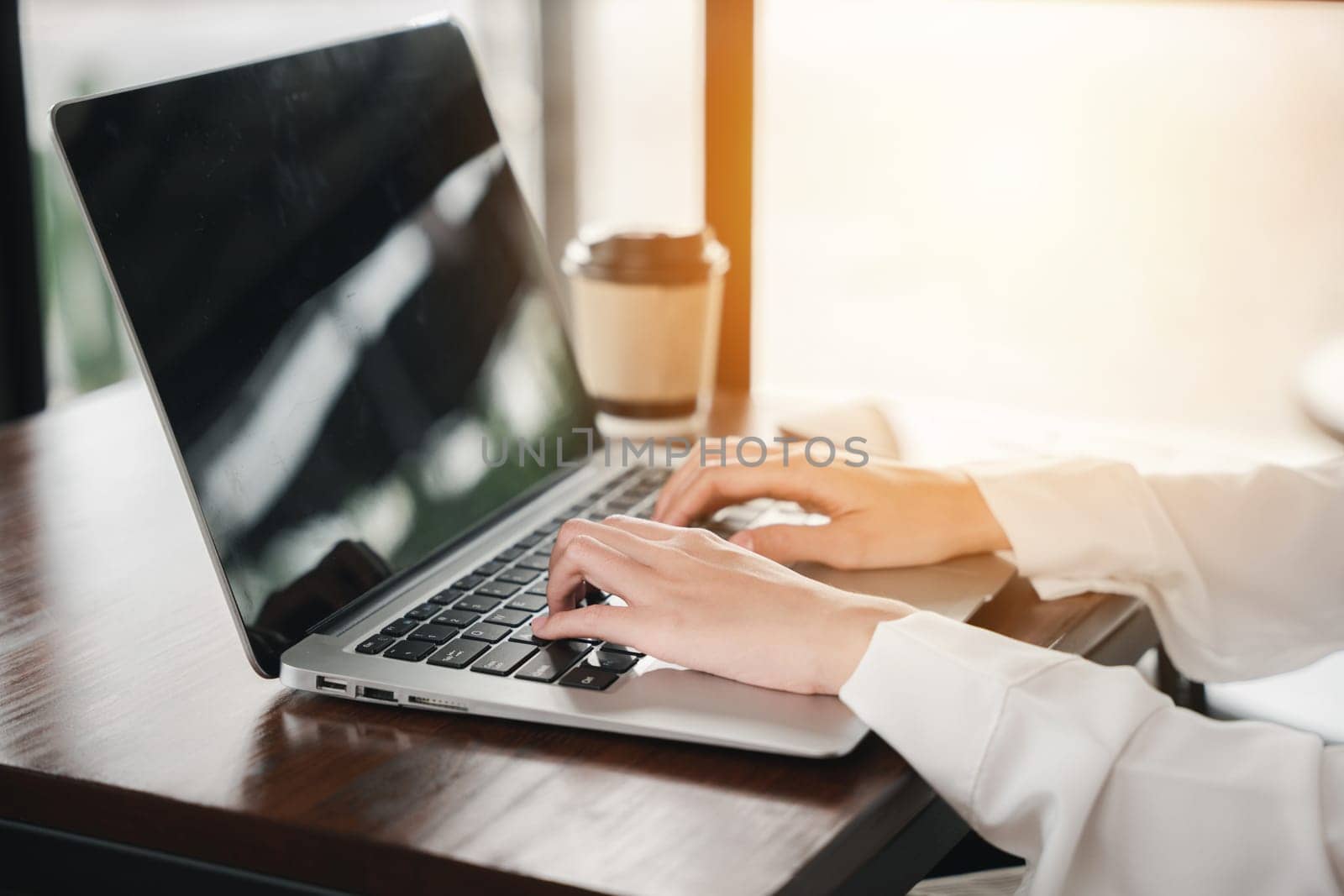 Happy beautiful freelancer typing keyboard on laptop, working online work outside office by Sorapop