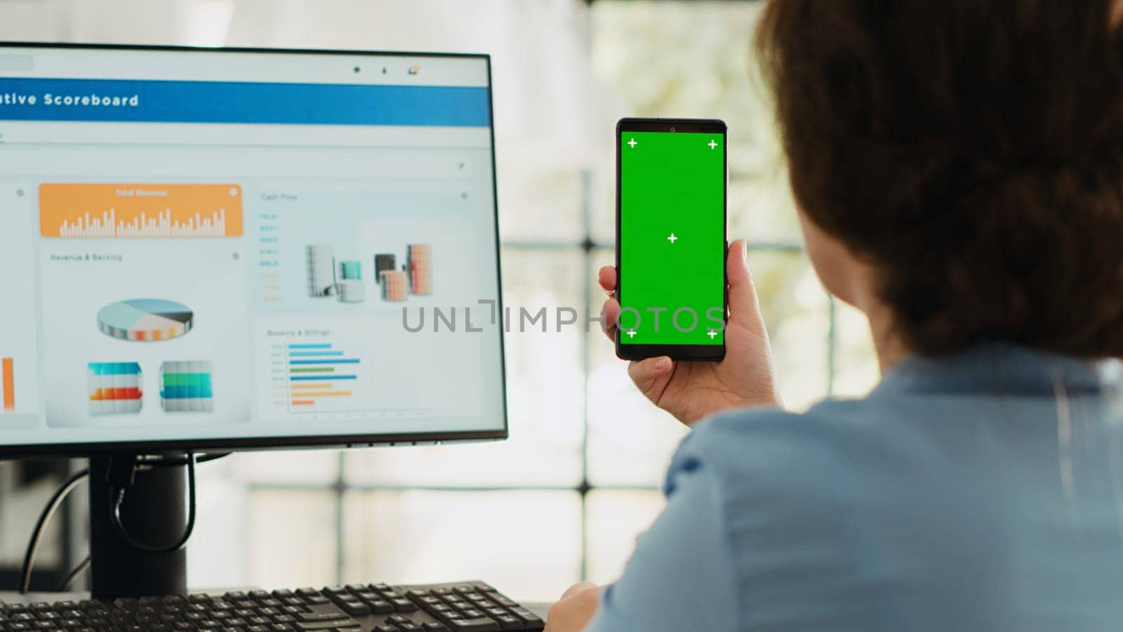 Manager holds phone with greenscreen in business agency workplace. Businesswoman working with isolated mockup template while showing blank chromakey display, startup job tasks.