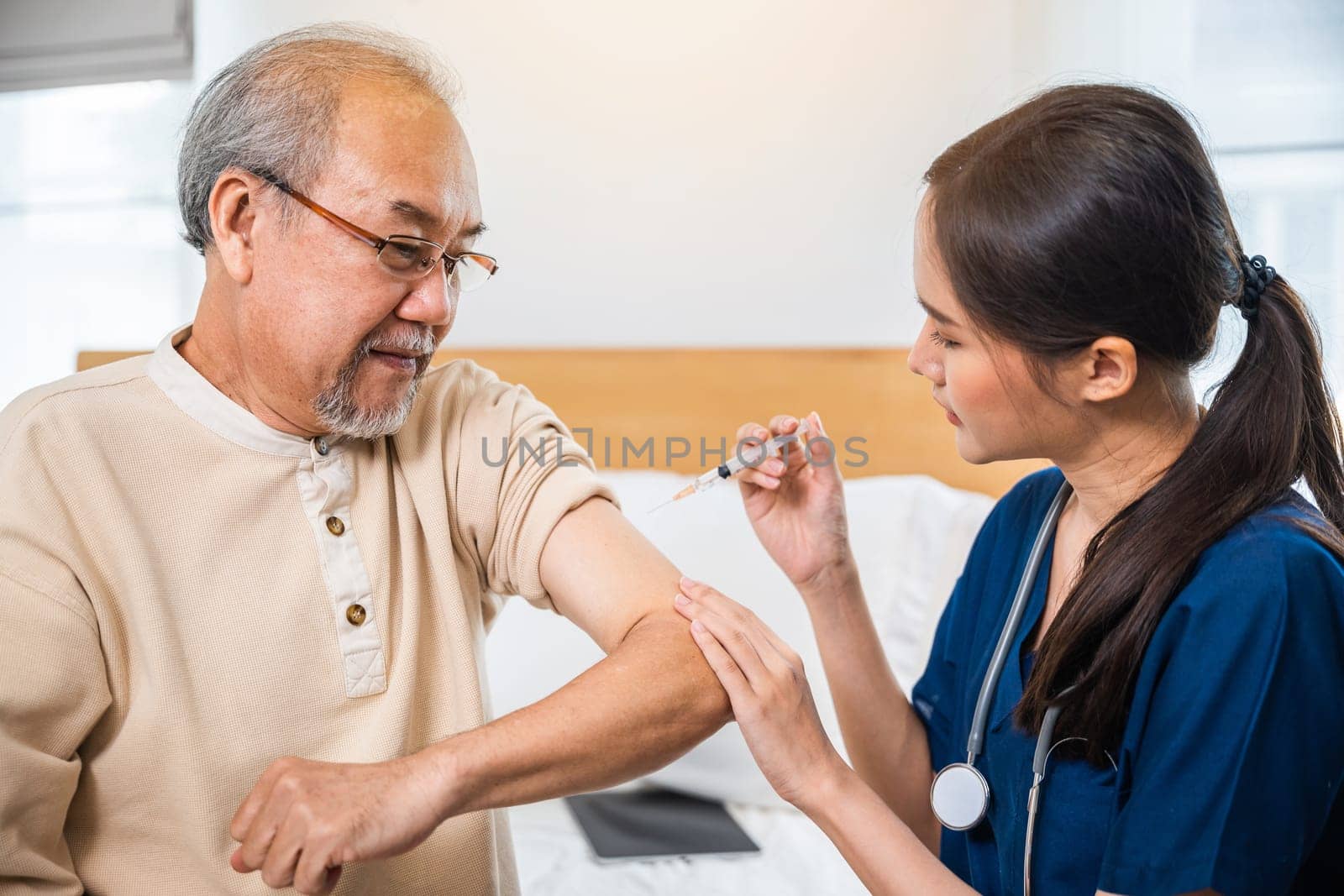 Asian elderly old man getting coronavirus vaccine with nurse, Doctor giving injection with syringe to senior man at clinic or hospital, medical and healthcare