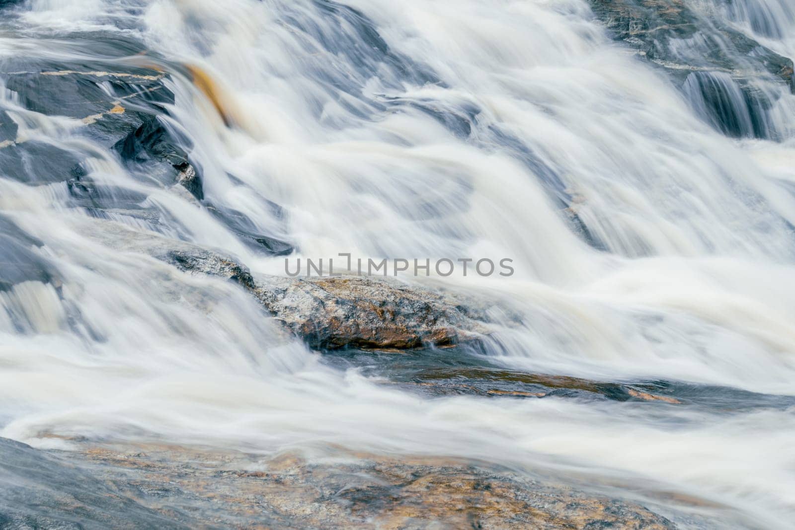 Beautiful waterfall in lush tropical forest, Chiang Mai, Thailand. Nature landscape. Long exposure of water falling on rock of mountainside. A waterfall flows on mountainside. World Water Day concept. by Fahroni