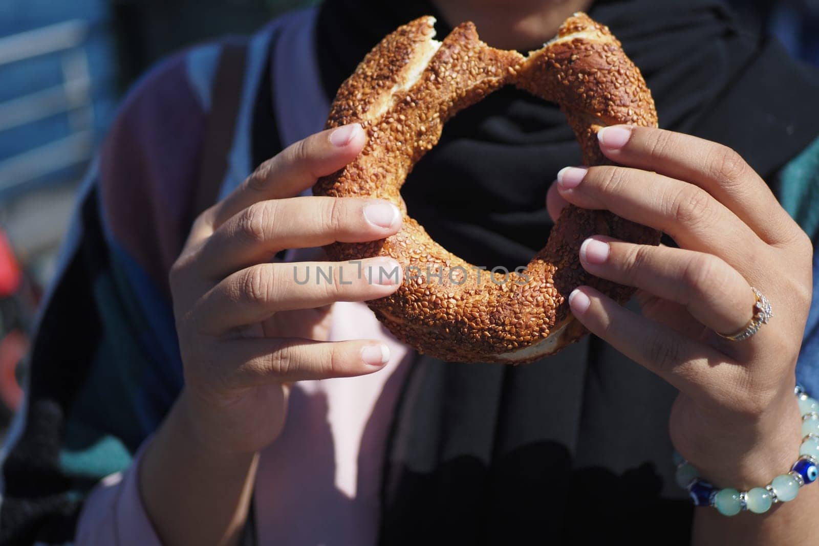 women holding a Turkish Bagel Simit outdoor ,