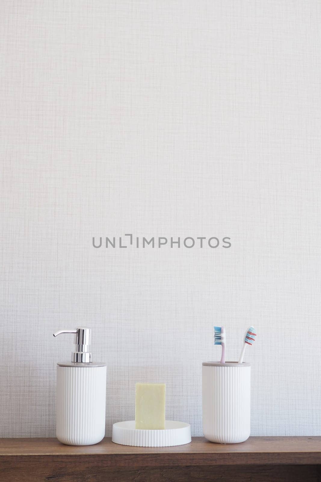 bathroom soap dispenser and toothbrush cup.