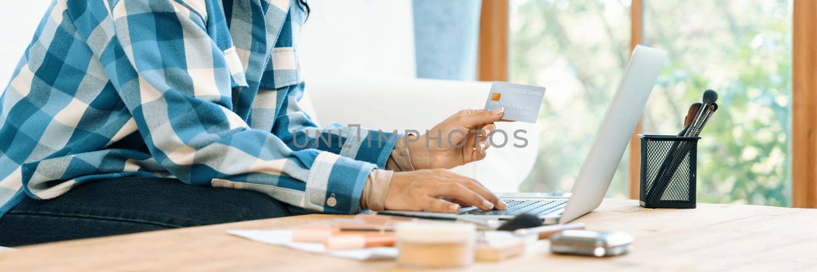 Close up credit card using for online payment, banking and shopping on the internet network with laptop computer showing credit card technology for online secured wallet top up and crucial purchase