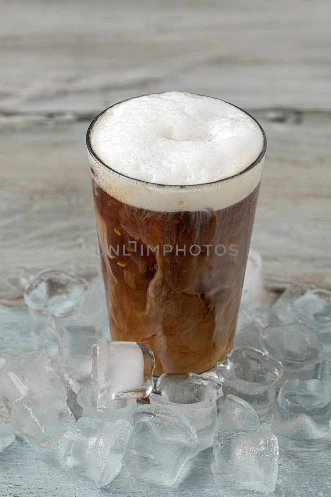 Iced coffee latte in glass cup on wooden table