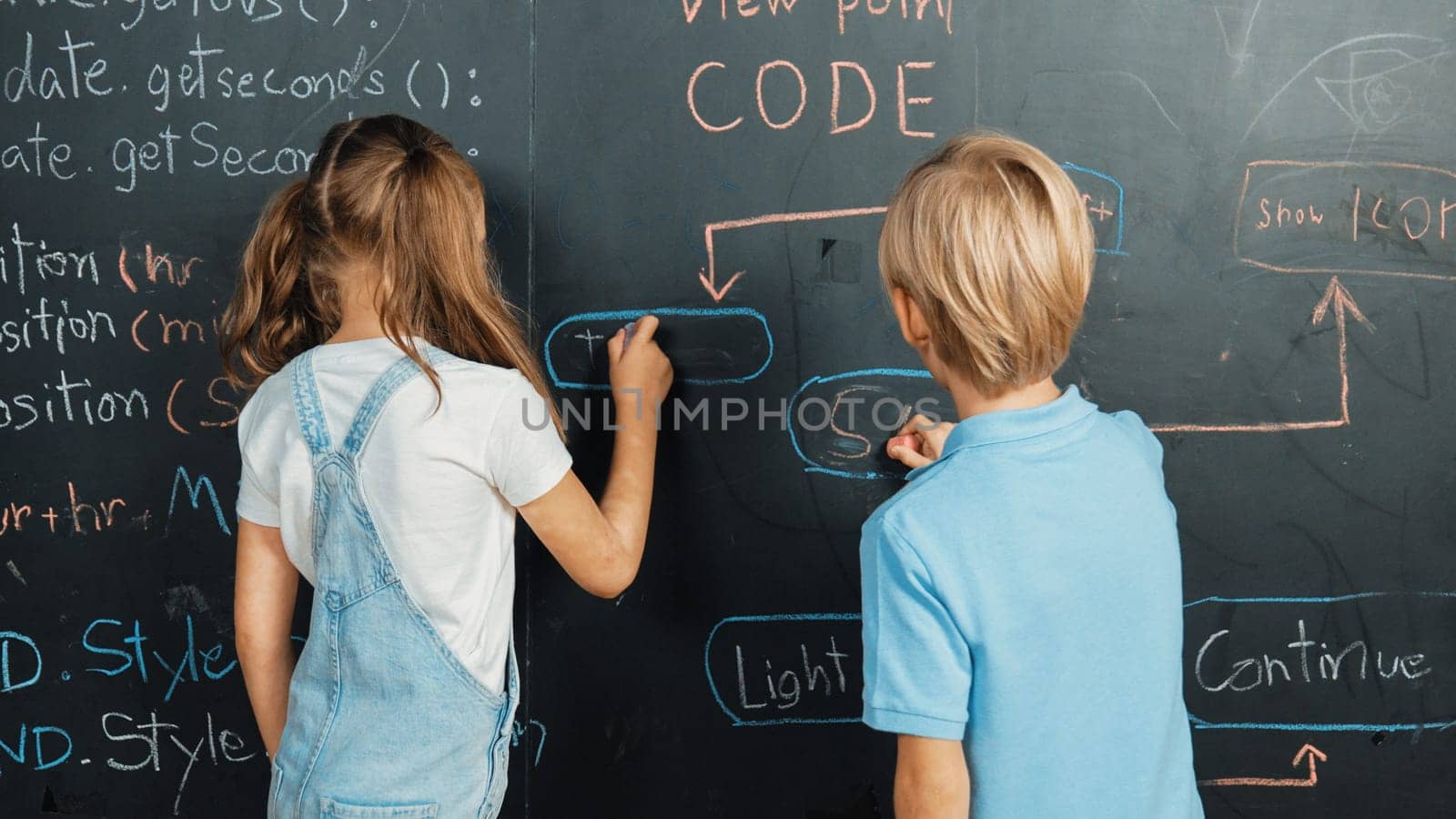 Caucasian girl and smart boy writing blackboard with engineering prompt or coding, programing system written in STEM technology classroom. Young cute student working together at blackboard. Erudition.