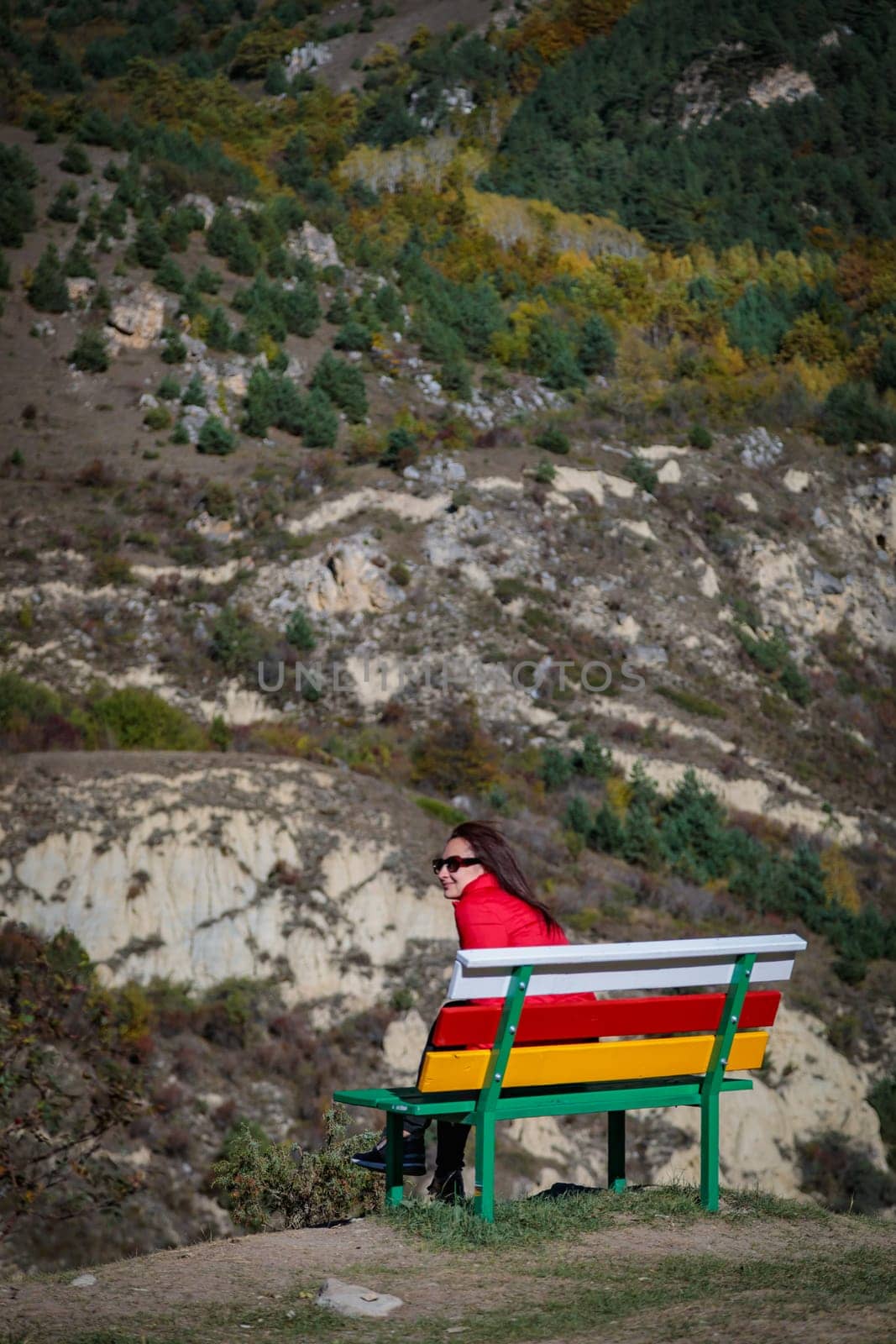 Girl on the background of mountains sitting on a bench by Yurich32