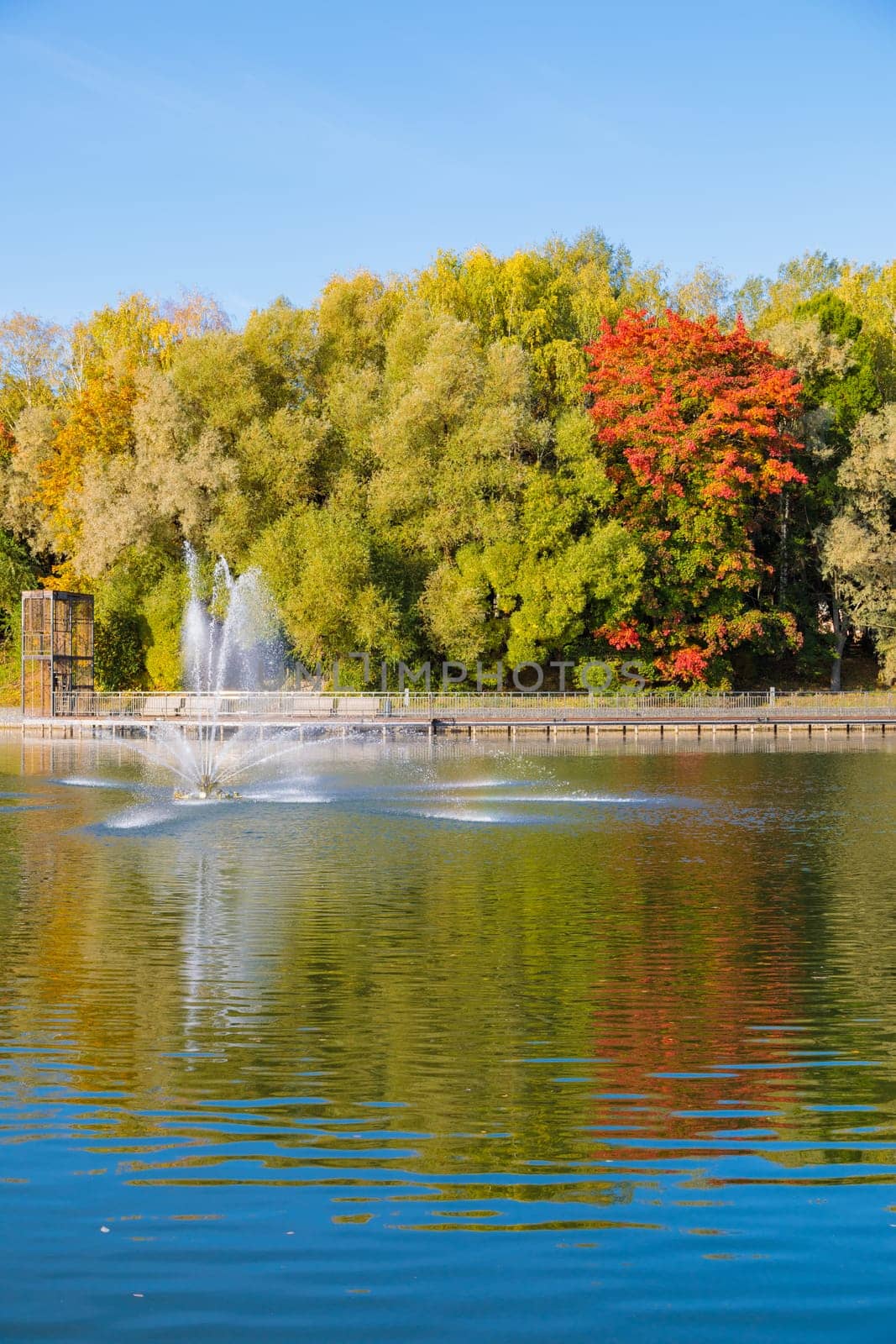 The magical beauty of the autumn park with a fountain on the pond brings peace and quiet by Yurich32
