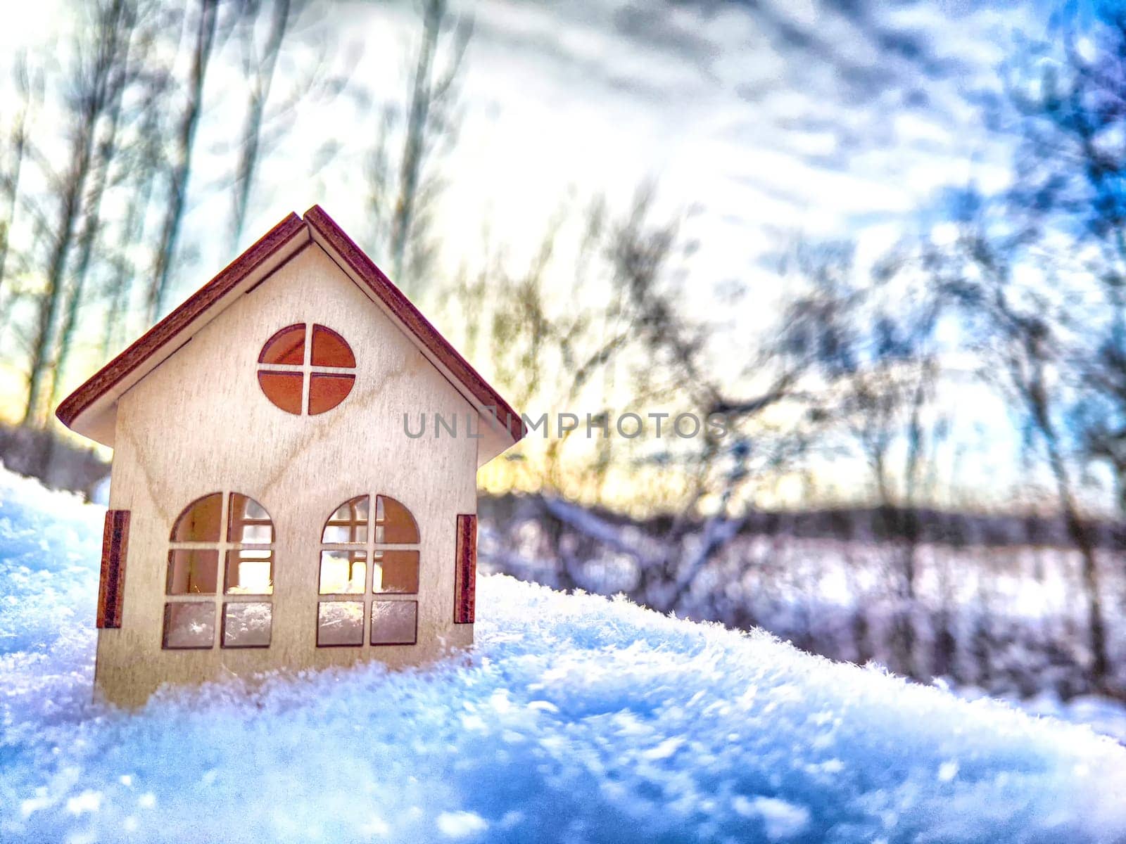 Wooden toy house on snow, natural abstract background. winter season concept. Christmas and new year holidays. symbol of cozy, loving family home. construction, sales, rental concept. copy space by keleny