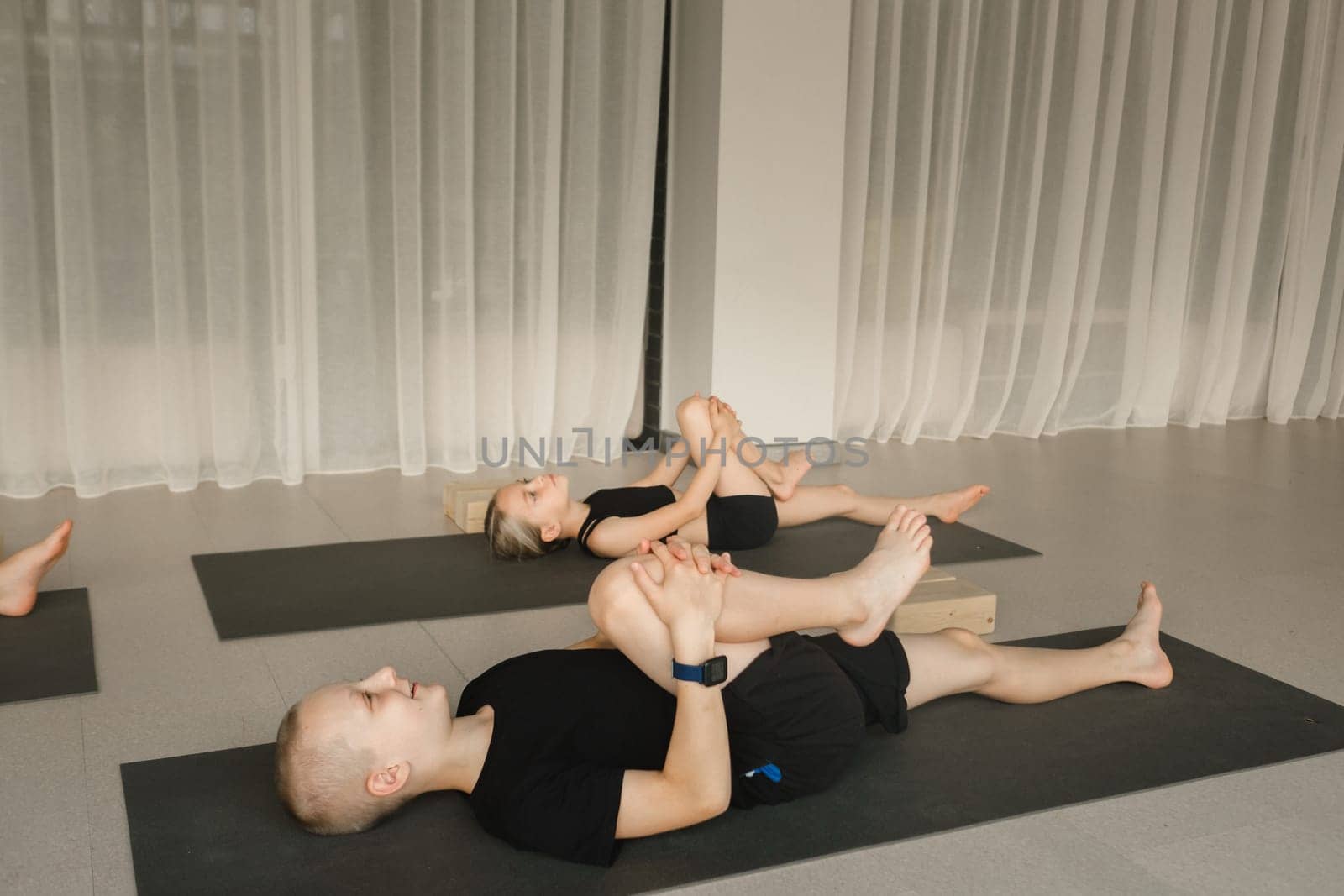 Children do Yoga in the fitness room. Children's gymnastics..