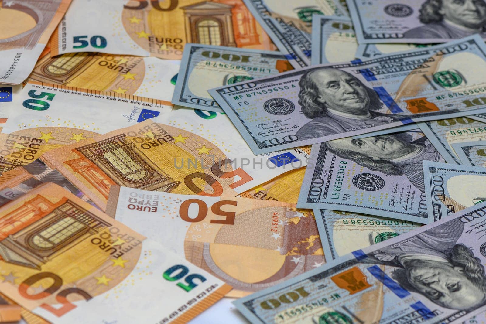 50 euro and 100 dollar bills scattered on the table as a background 1