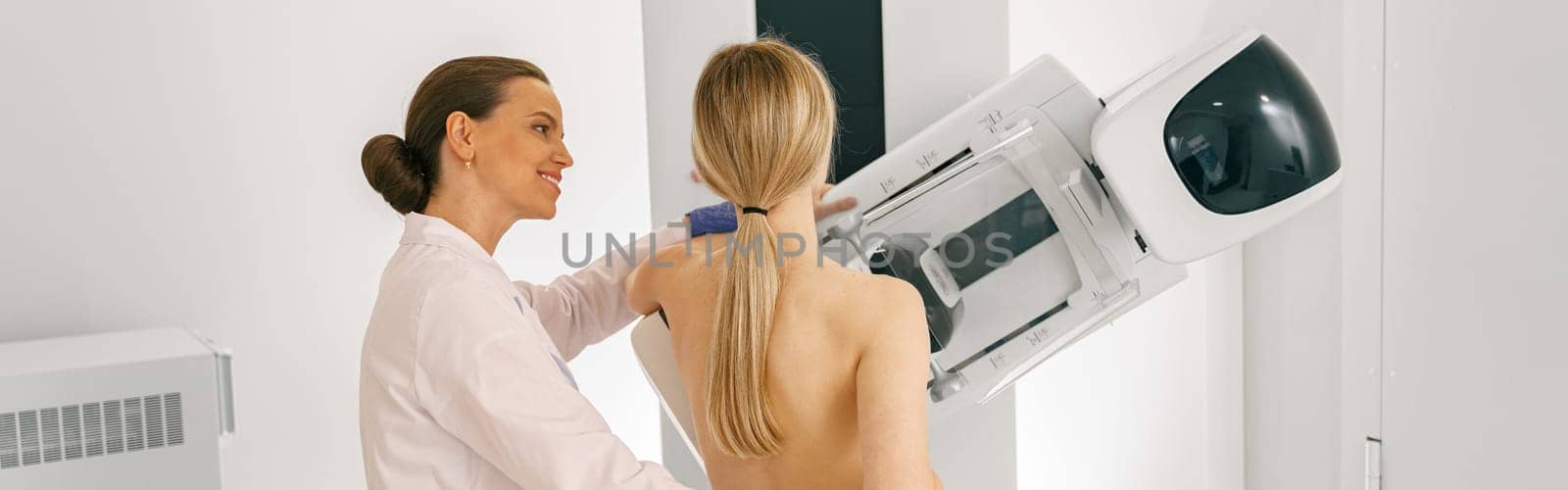 Woman doing mammogram x ray for breast cancer prevention screening at hospital