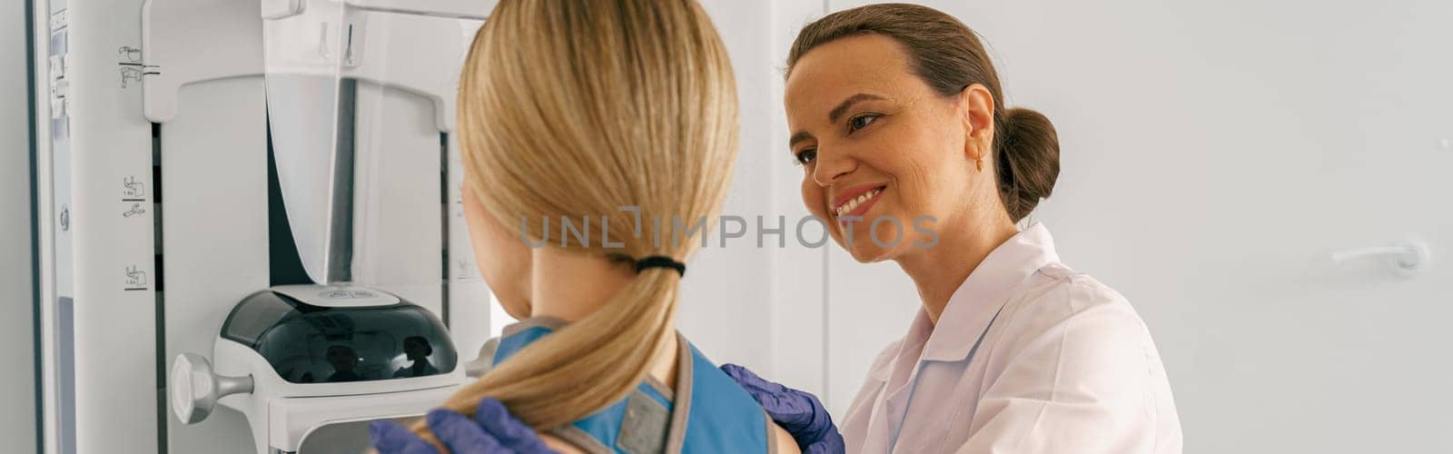 Woman doing mammogram x ray for breast cancer prevention screening at hospital