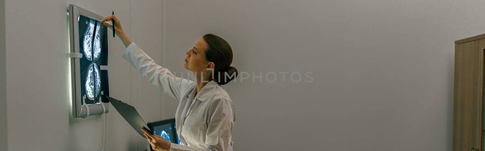 Side view of professional doctor radiologist analyzing scan MRI images in medical center by Yaroslav_astakhov