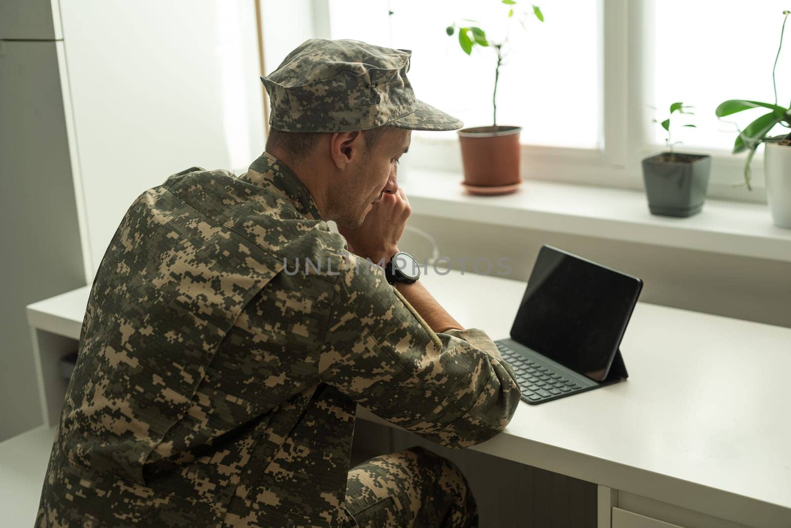 Happy soldier using laptop. Military service by Andelov13