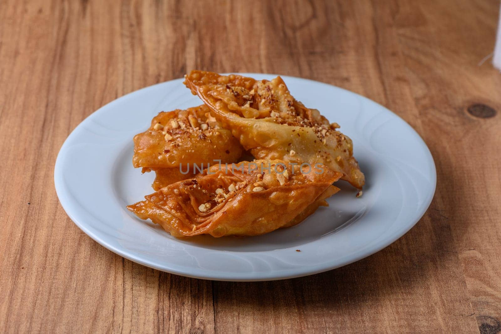 Turkish baklava, sweet dessert with honey on a light plate 2 by Mixa74