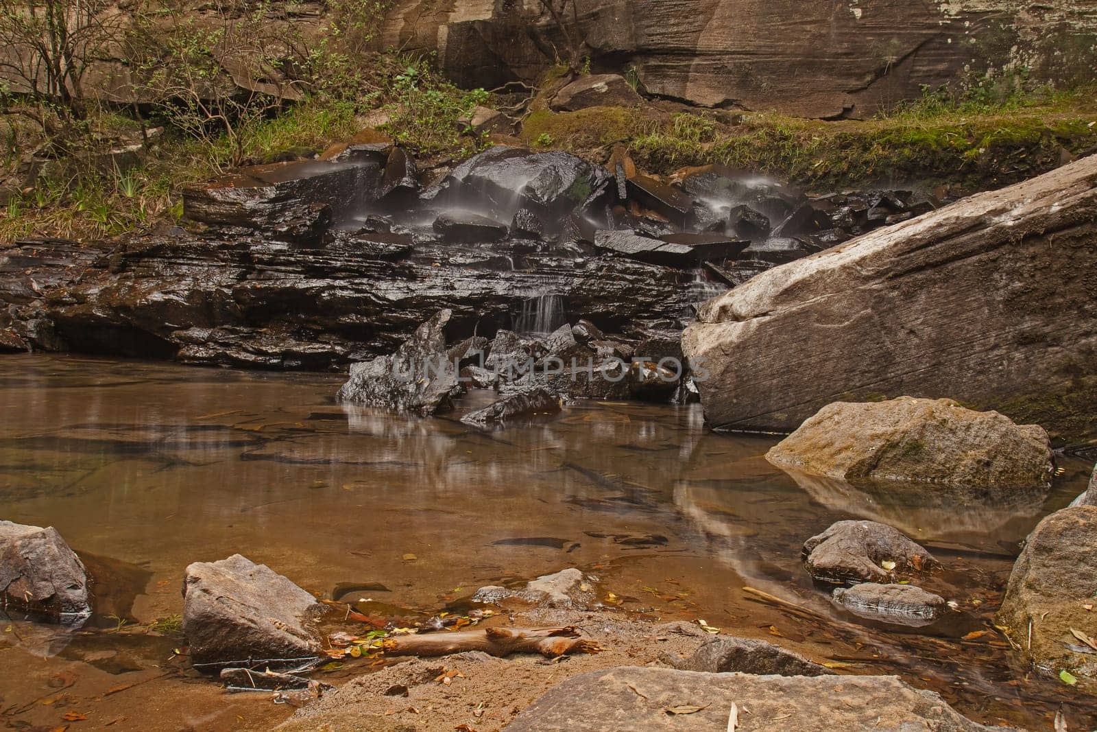 The  water of the Golide River hits the basalt rocks at the base of the Sunday Fals in the Royal Natal National Park, Drakensberg South Africa