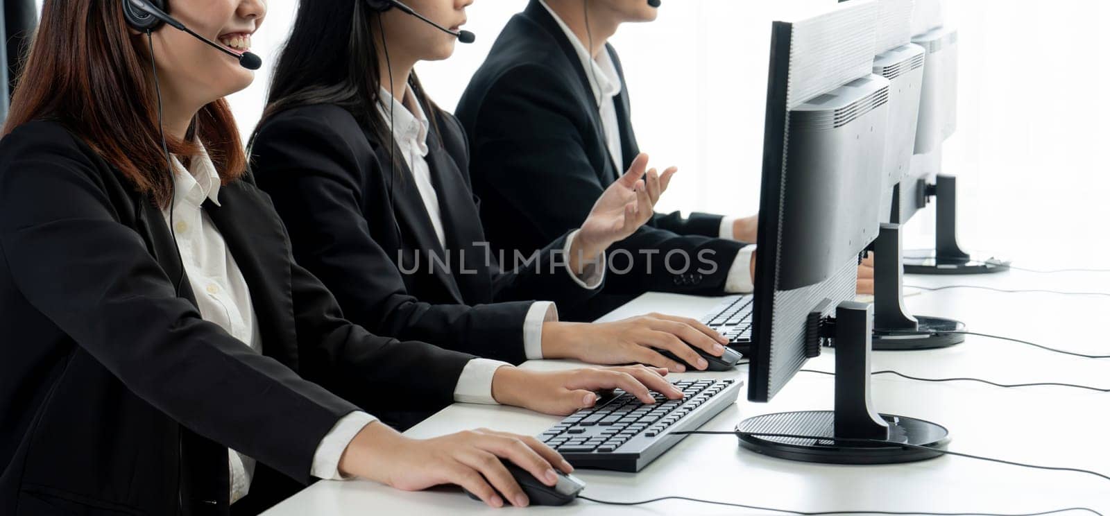 Business people wearing headset working in office to support remote customer or colleague. Call center, telemarketing, customer support agent provide service on telephone video conference oratory call