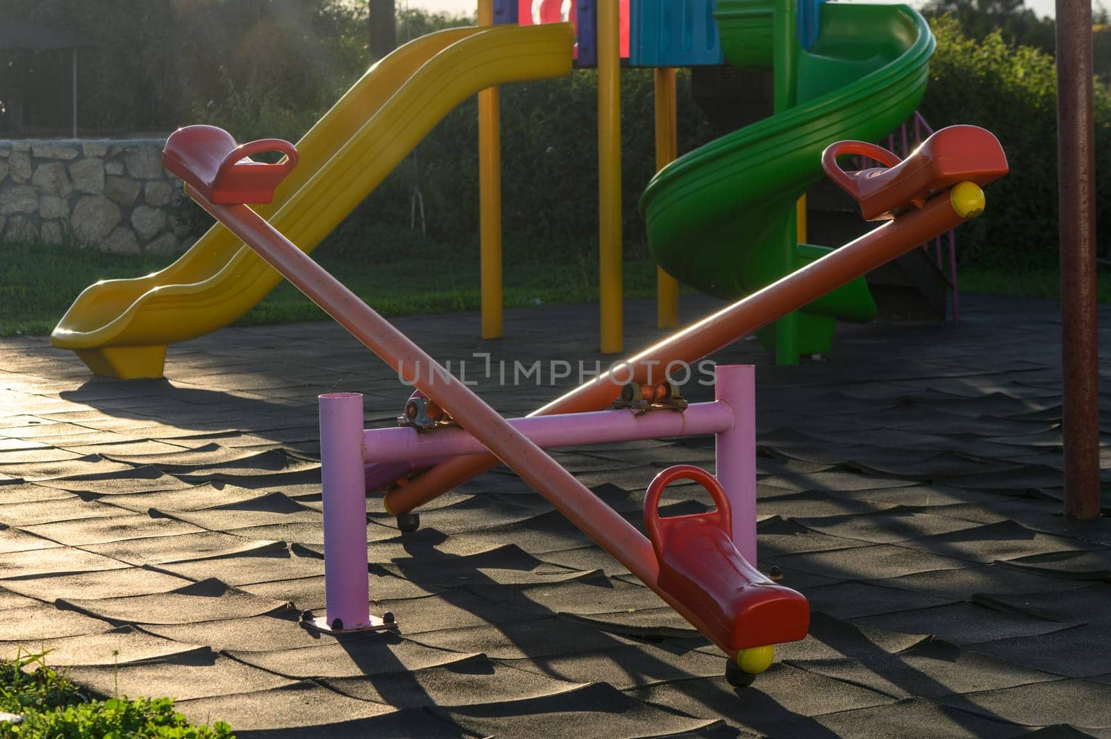 children's swings colorful on the playground in the village 1 by Mixa74