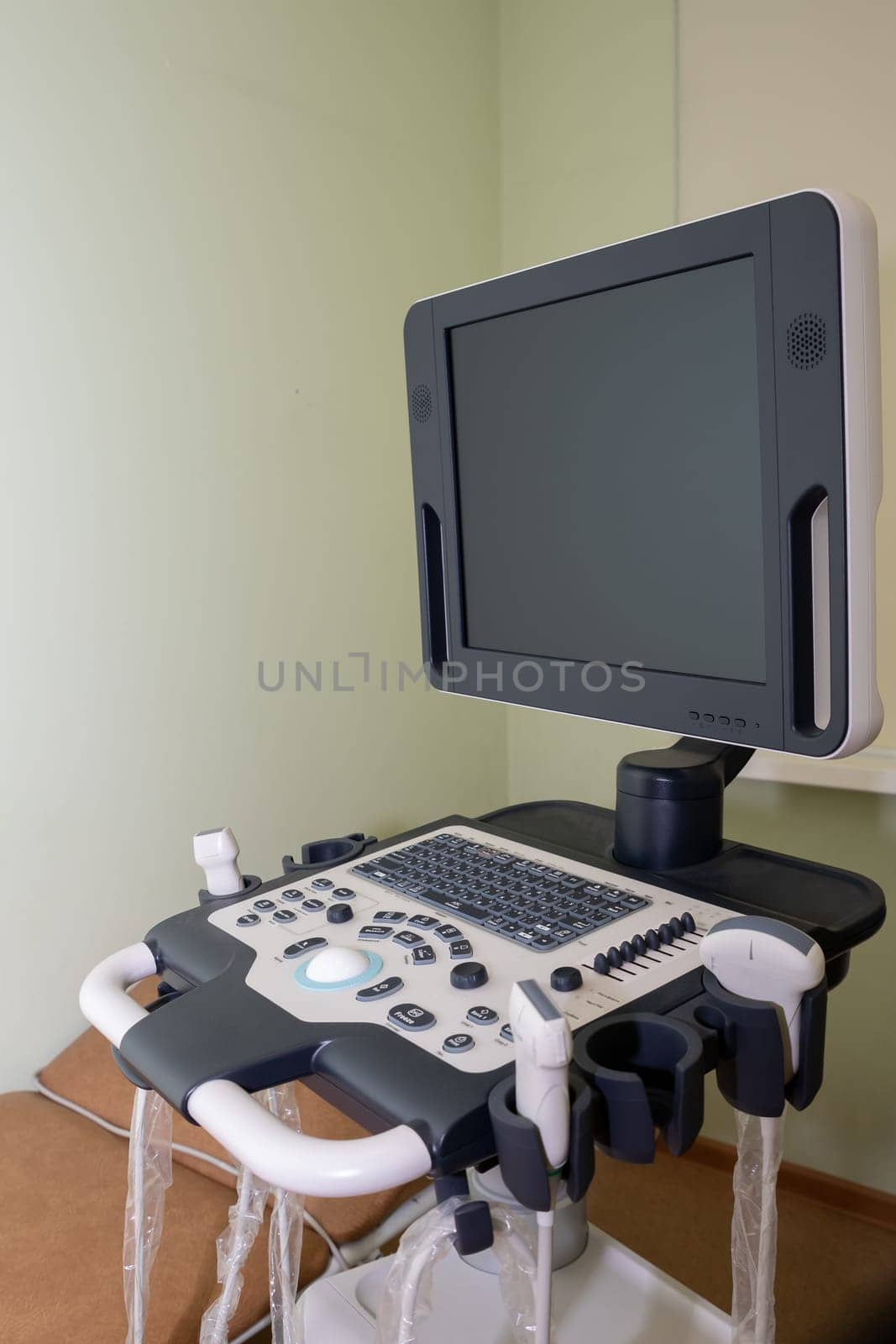 Ultrasound machine with sensor close-up. The sensor of the ultrasound machine in the doctor's hand on the background of ultrasound.