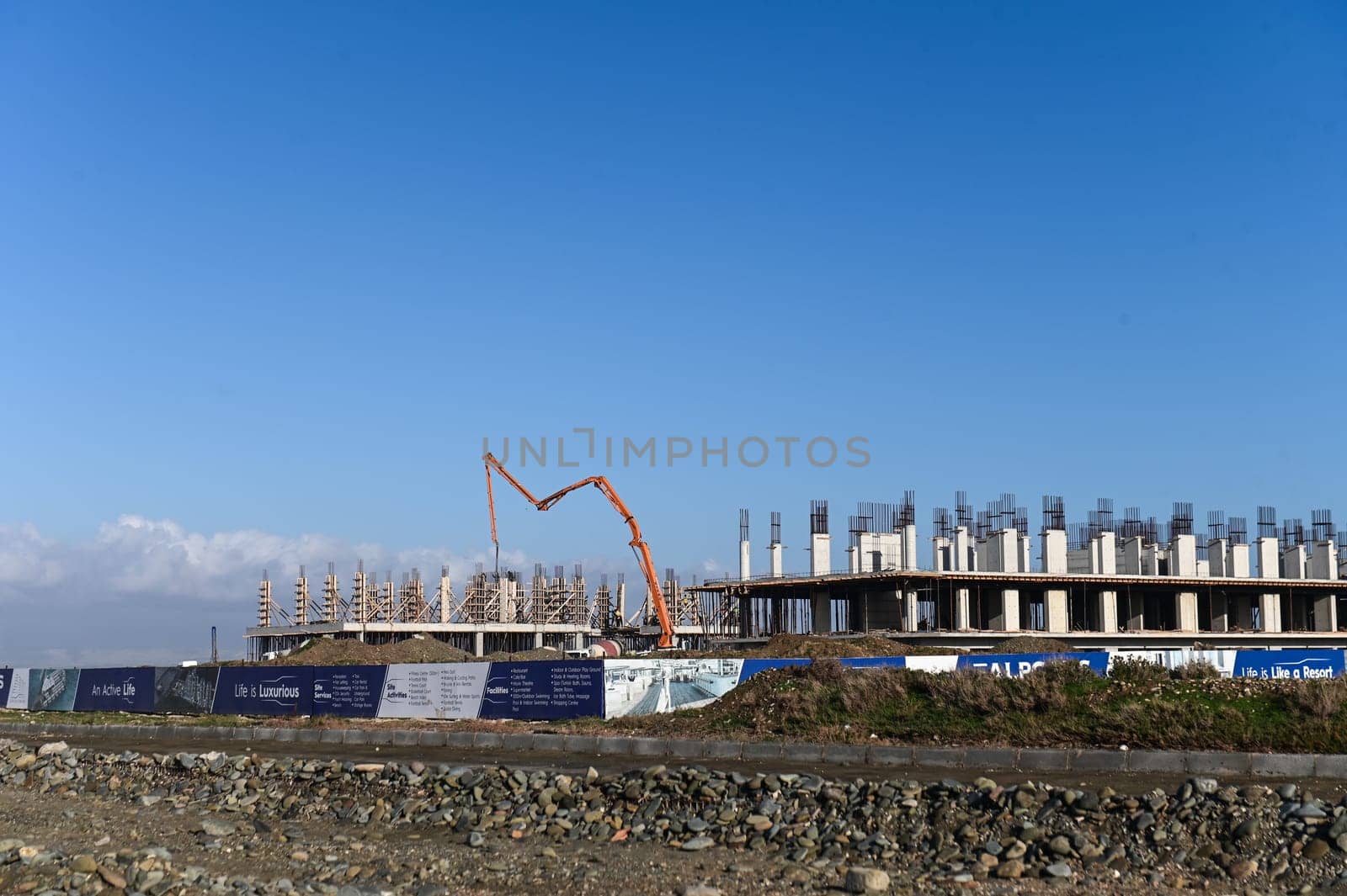 machine for pouring concrete at the construction site of a new complex near the sea 10