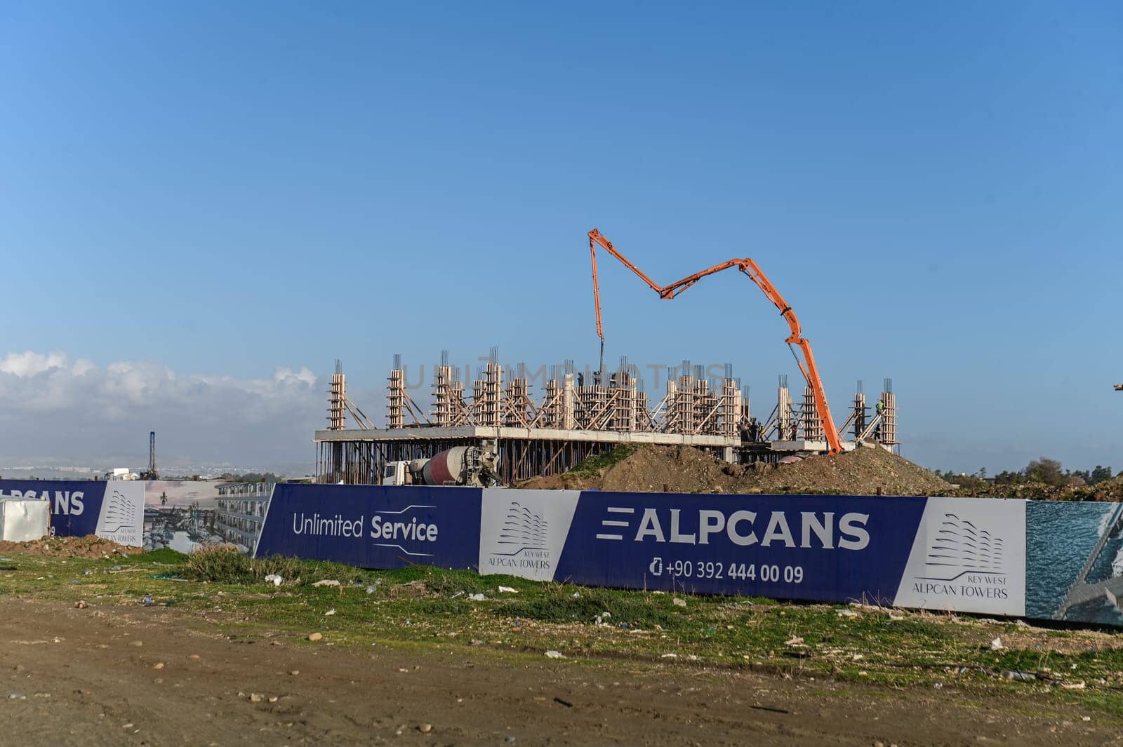 machine for pouring concrete at the construction site of a new complex near the sea